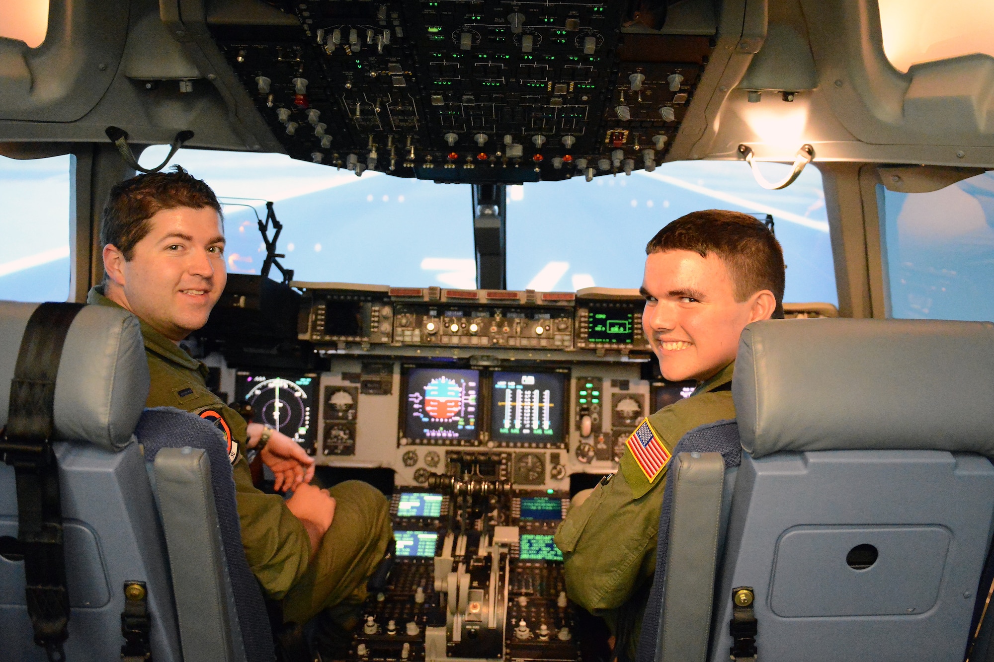 Jerry Connolly (right), pilot for a day, and 1st Lt. Brian Ray, 4th Airlift Squadron pilot, prepare for takeoff in a C-17 Globemaster III simulator July 14, 2014 at Joint Base Lewis McChord, Wash. With the assistance of Ray, Connolly was allowed to fly the C-17 attempting various maneuvers and landing. (U.S. Air Force photo/Airman 1st Class Jacob Jimenez) 