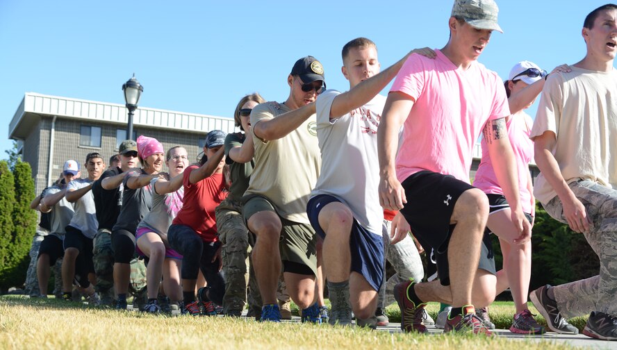 Members perform team lunges as part of the GORUCK Light Challenge July 12, 2014, at Mountain Home Air Force Base, Idaho. The new Air Force pilot program aims to get Airmen, dependents and Department of Defense employees involved in activities challenging them as a team and also encouraging a healthy, resilient lifestyle. (U.S. Air Force photo by Senior Airman Benjamin Sutton/Released)
