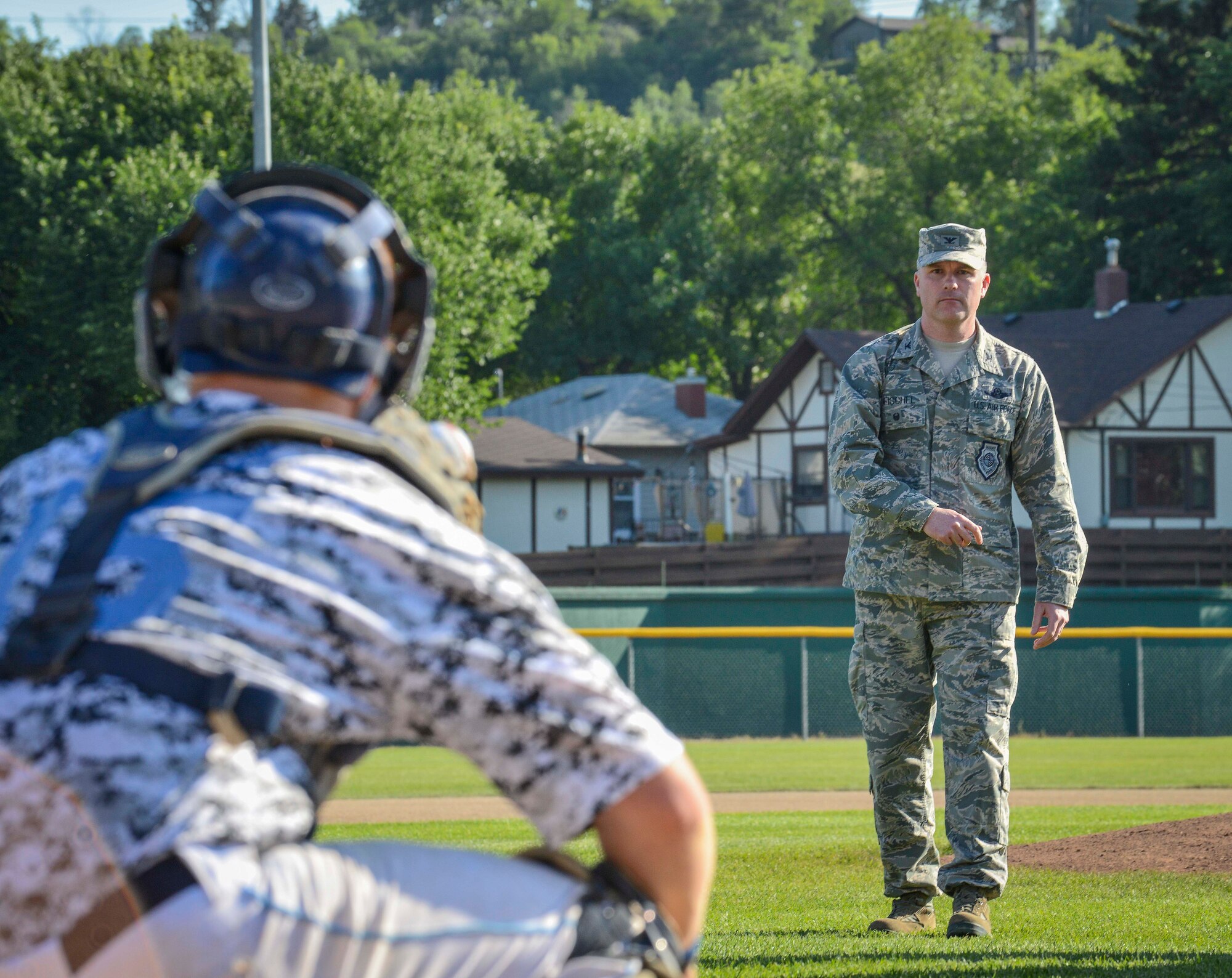 Col. Jeffrey Neischel, 5th Bomb Wing vice commander, throws out the first pitch at the game between the Minot Vistas and the Bismarck Governors at Corbett Field in Minot, N.D., July 14, 2014. In addition to throwing the first pitch, Neischel also marched with the local American Legion Honor Guard, and presented the members of the Minot Vistas with their player’s certificates. (U.S. Air Force photo/Senior Airman Stephanie Morris)