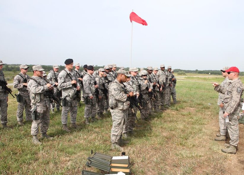 Air Force Reserve Command reservists gather to hear instructions. The 932nd Security Forces Squadron members listened to land navigation instructions Sunday, July 13, before heading out into the field under a red flag.  A variety of skills and safety cautions were focused on during the two day event conducted under the 932nd Mission Support Group banner.  (U.S. Air Force photo/Tech. Sgt. Christopher Parr)