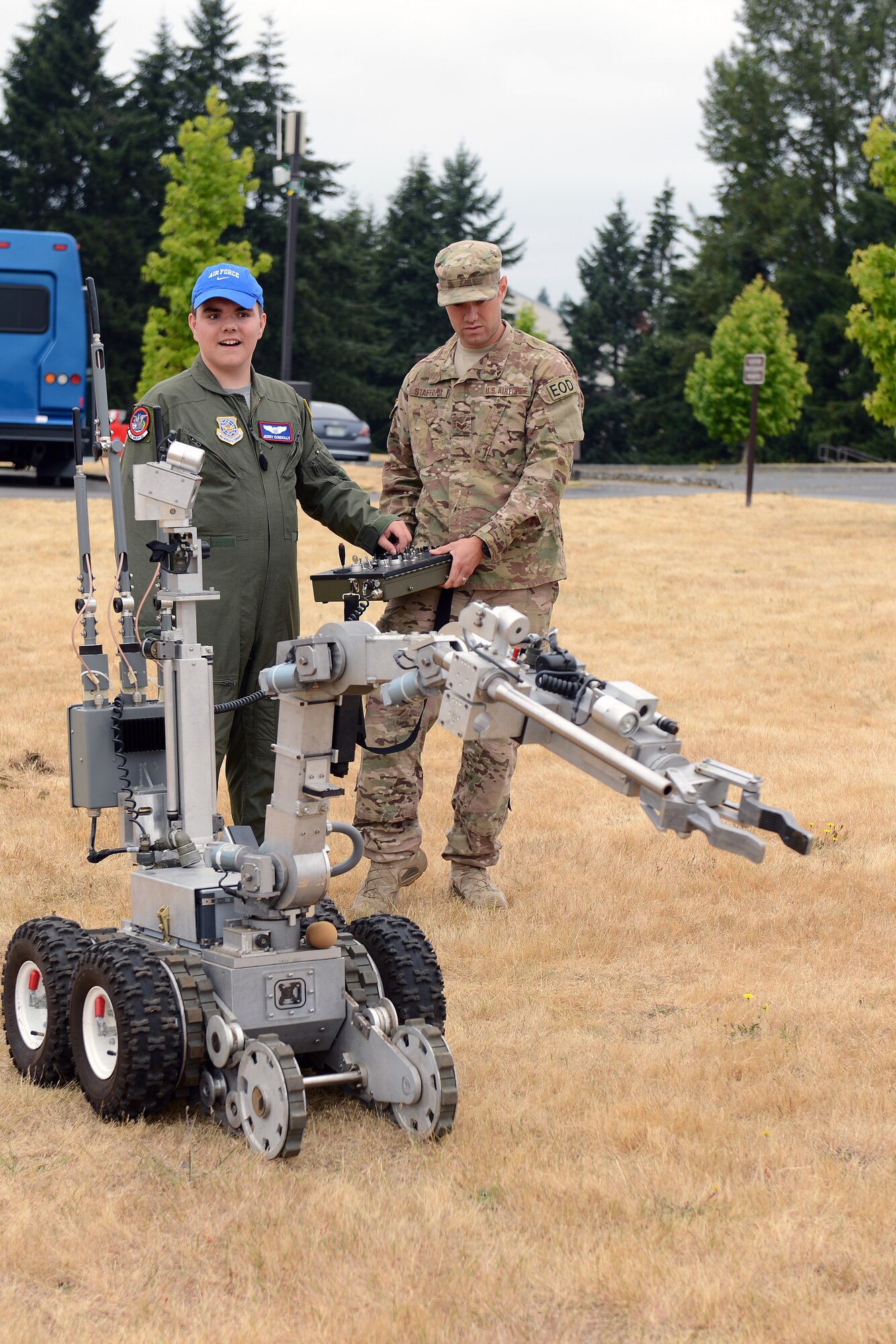 Jerry Connolly(left), 4th Airlift Squadron’s pilot for a day, operates an explosive ordnance disposal robot with Senior Airman Mark Stafford, 627th Civil Engineer Squadron EOD technician, July 14, 2014, at Joint Base Lewis-McChord, Wash. While visiting EOD, Connolly got to pull the trigger to detonate explosives on the EOD range. (U. S. Air Force photo/Airman 1st Class Jacob Jimenez) 