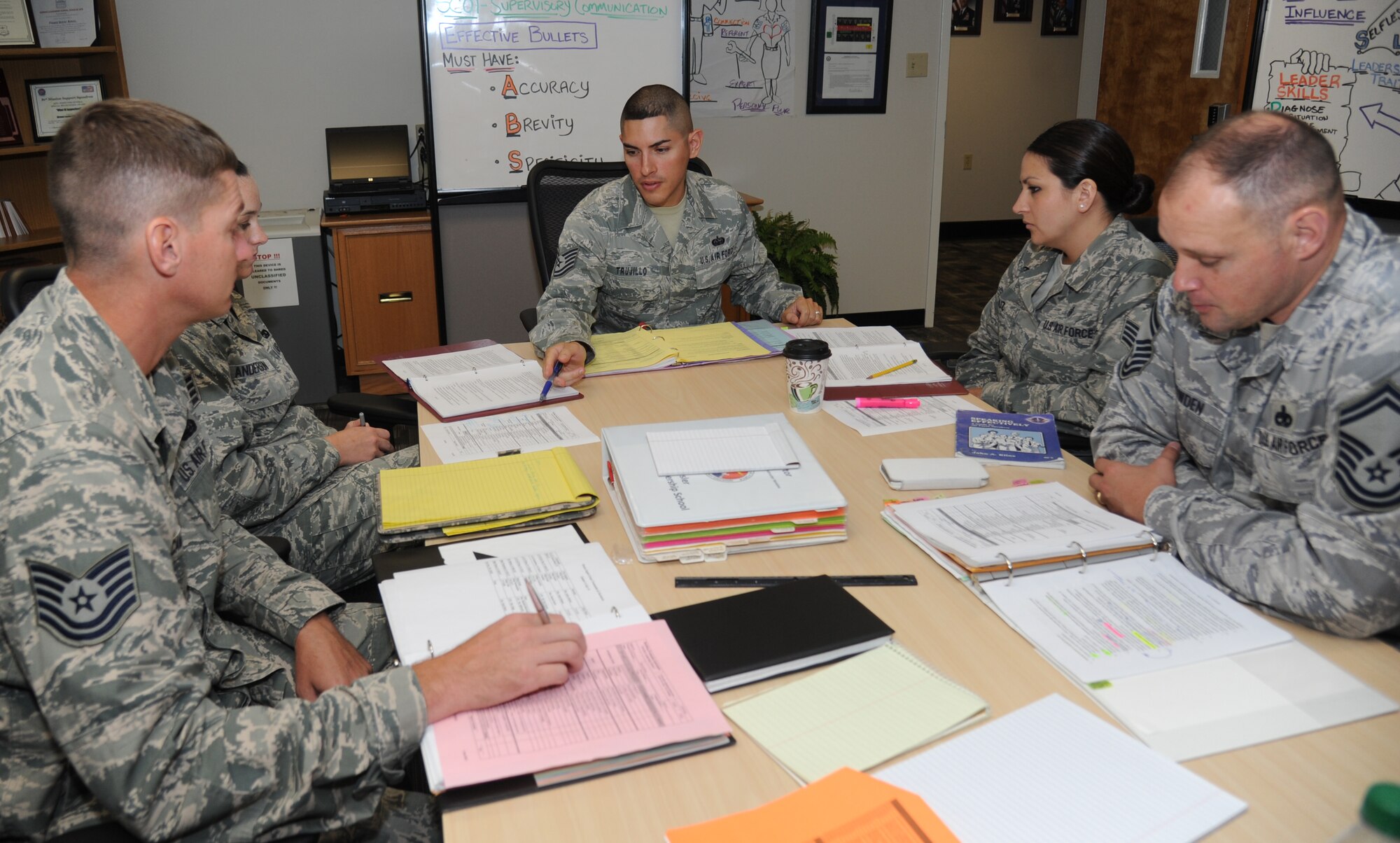 Tech. Sgt. Alberto Trujillo, 81st Force Support Squadron Airman Leadership School instructor, reviews lesson plans with fellow instructors July 15, 2014, at the ALS building, Keesler Air Force Base, Miss.  Trujillo entered the Air Force as a cyber transport specialist and has been an instructor at the Airman Leadership School for four years, where he currently teaches leadership skills to Airmen.  (U.S. Air Force photo by Kemberly Groue)