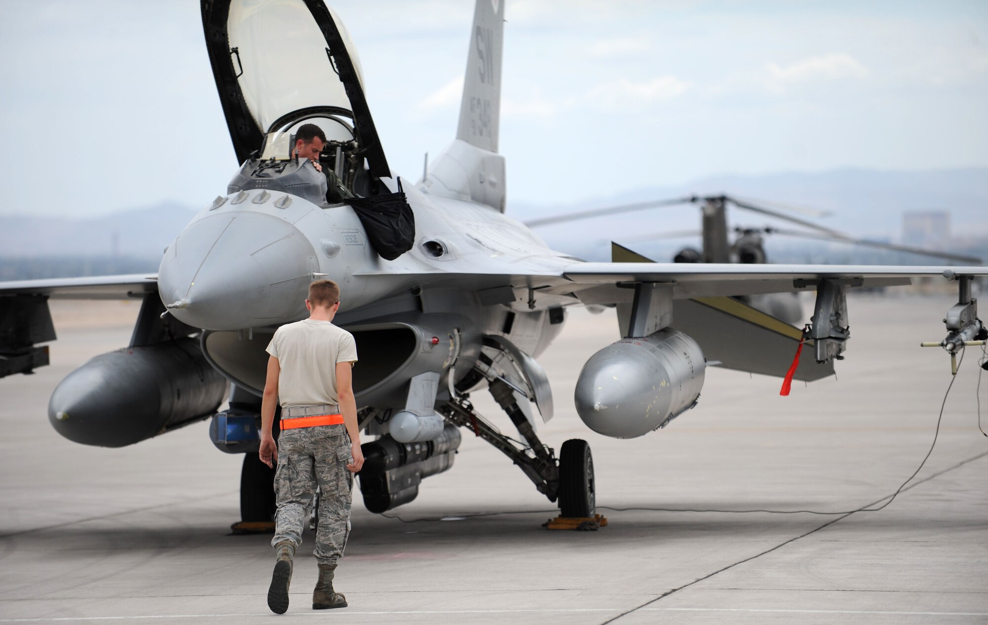Airman 1st Class James Yonker, crew chief apprentice, 20th Fighter Wing, 79th Aircraft Maintenance Unit, Shaw Air Force Base, S.C., performs a foreign-object damage walk prior to engine start while Capt. Jeff Randolph, 20th Fighter Wing, 79th Fighter Squadron F-16 Falcon pilot, performs preflight cockpit checks during Red Flag 14-3 on Nellis AFB, Nev., July 14, 2014. More than 2,300 personnel will participate in the two week long exercise, scheduled to run July 14 to 25, with the 28th Bomb Wing from Ellsworth AFB, S.D., as the lead wing. (U.S. Air Force photo by Tech. Sgt. Jerry Fleshman/Released)