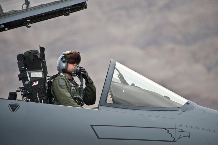 Capt. Matthew Olde, 335th Fighter Squadron F-15E Strike Eagle pilot, Seymour Johnson Air Force Base, N.C. prepares to close the canopy of his aircraft during the start of Red Flag 14-3 July 14, 2014, Nellis AFB, Nev. Red Flag provides aircrews and ground support operations an opportunity to integrate and practice combat operations.  (U.S. Air Force photo by Lawrence Crespo) 