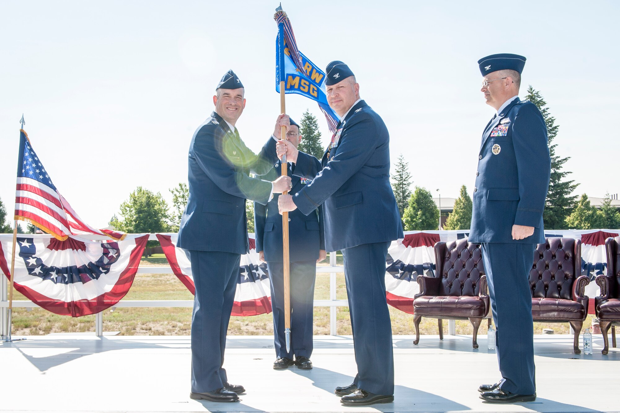 Col. Brian Newberry receives the guidon from Col. Konrad Klausner during the 92nd Mission Support Group change of command ceremony at Fairchild Air Force Base, Washington, July 11, 2014. Klausner steps down as the 92nd MSG commander as Col. David Stookey steps into the role. Stookey comes to Fairchild after serving for more than two years as the deputy director for information technology transformation at the Joint Staff Directorate from Command, Control, Communications Computers and Cyber. Klausner heads for the Headquarters U.S. Air Force in District of Columbia to serve as the chief of Global Mobility Division, Directorate of Operations, Deputy Chief of Staff for Operations, Plans and Requirements. The change of command ceremony is a tradition that represents a formal transfer of authority and responsibility. Newberry is the 92nd Air Refueling Wing commander. (U.S. Air Force photo by Staff Sgt. Benjamin W. Stratton/Released)