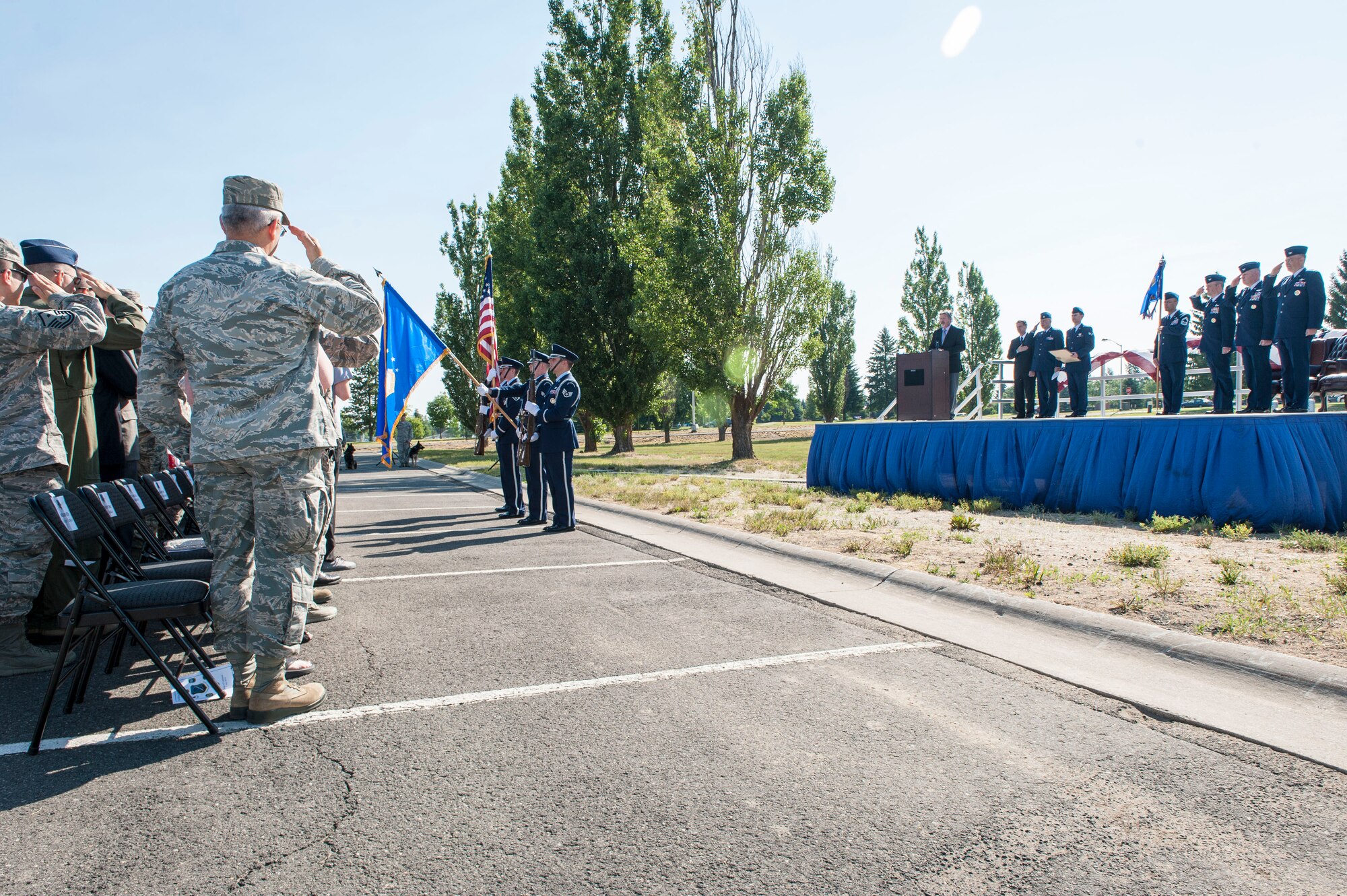 Fairchild Airmen and community members salute the American flag during the singing of the national anthem as part of the 92nd Mission Support Group change of command ceremony at Fairchild Air Force Base, Washington, July 11, 2014. The change of command ceremony is a tradition that represents a formal transfer of authority and responsibility. (U.S. Air Force photo by Staff Sgt. Benjamin W. Stratton/Released)