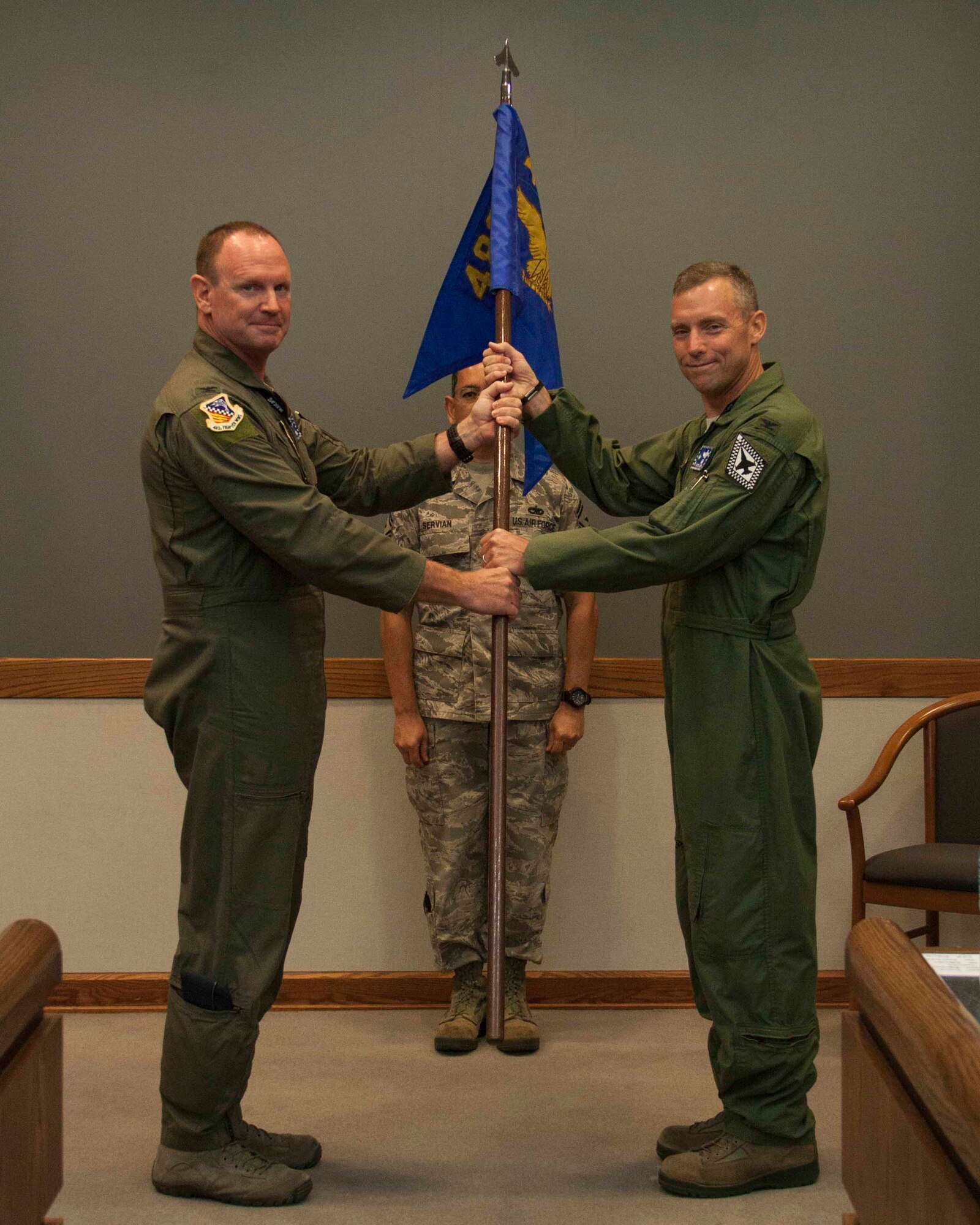 Col. Christian Funk, commander of the 482nd Fighter Wing, passes the 482nd Operations Group guidon to Col. David W. Smith, commander of the 482nd Operations Group, during an Assumption of Command ceremony July 13 at Homestead Air Reserve Base, Florida. (U.S. Air Force photo by/Senior Airman Jaimi L. Upthegrove)