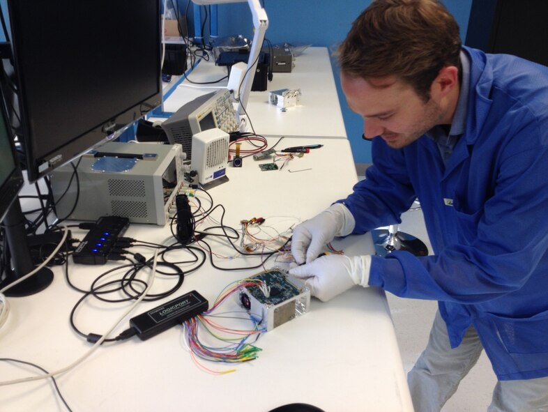 Blue Canyon Technologies employee Matthew Carton works on the eXact Attitude Control Technology (XACT) at their facility in Boulder, Colorado.  XACT is an all-in-one unit provides satellite control and orientation capability and is ultimately expected to result in a low-cost platform for missions and rapid launches. (Courtesy photo)