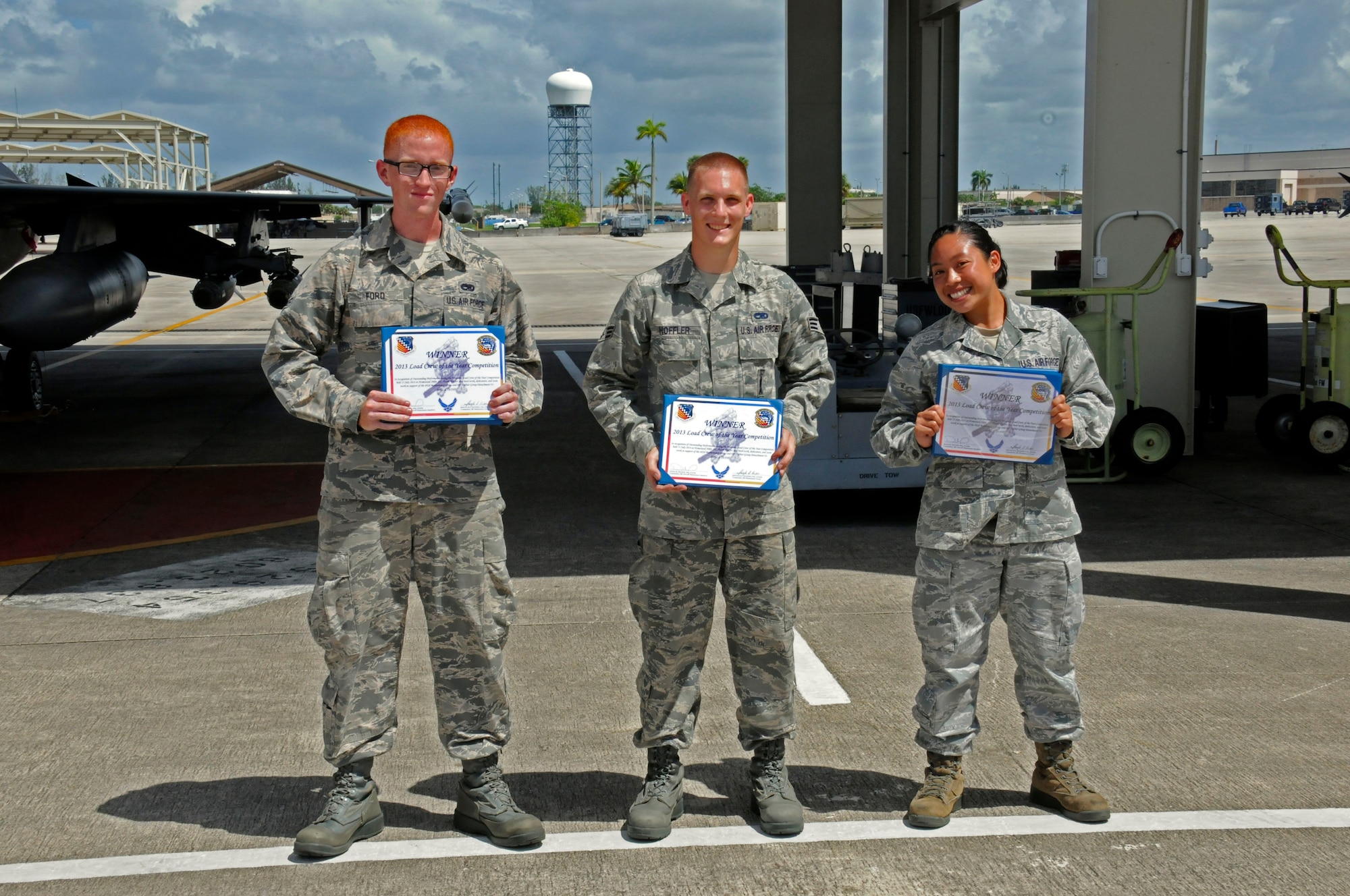 Staff Sgt. Danessa Gali, Senior Airman Stephen Hoffler, and Senior Airman
William Ford, members of the 495th Fighter Group, Detachment 93, were the
winners of the 482nd Aircraft Maintenance Squadron's Load Crew of the Year
Competition at Homestead Air Reserve Base, Fla., July 13. The "Load Toads"
were evaluated in four areas to determine the winner: dress and personal
appearance, tool kit inspection, a general knowledge test, and actual
munitions loading to include speed and proficiency. (U.S. Air Force
photo/Senior Airman Nicholas Caceres)