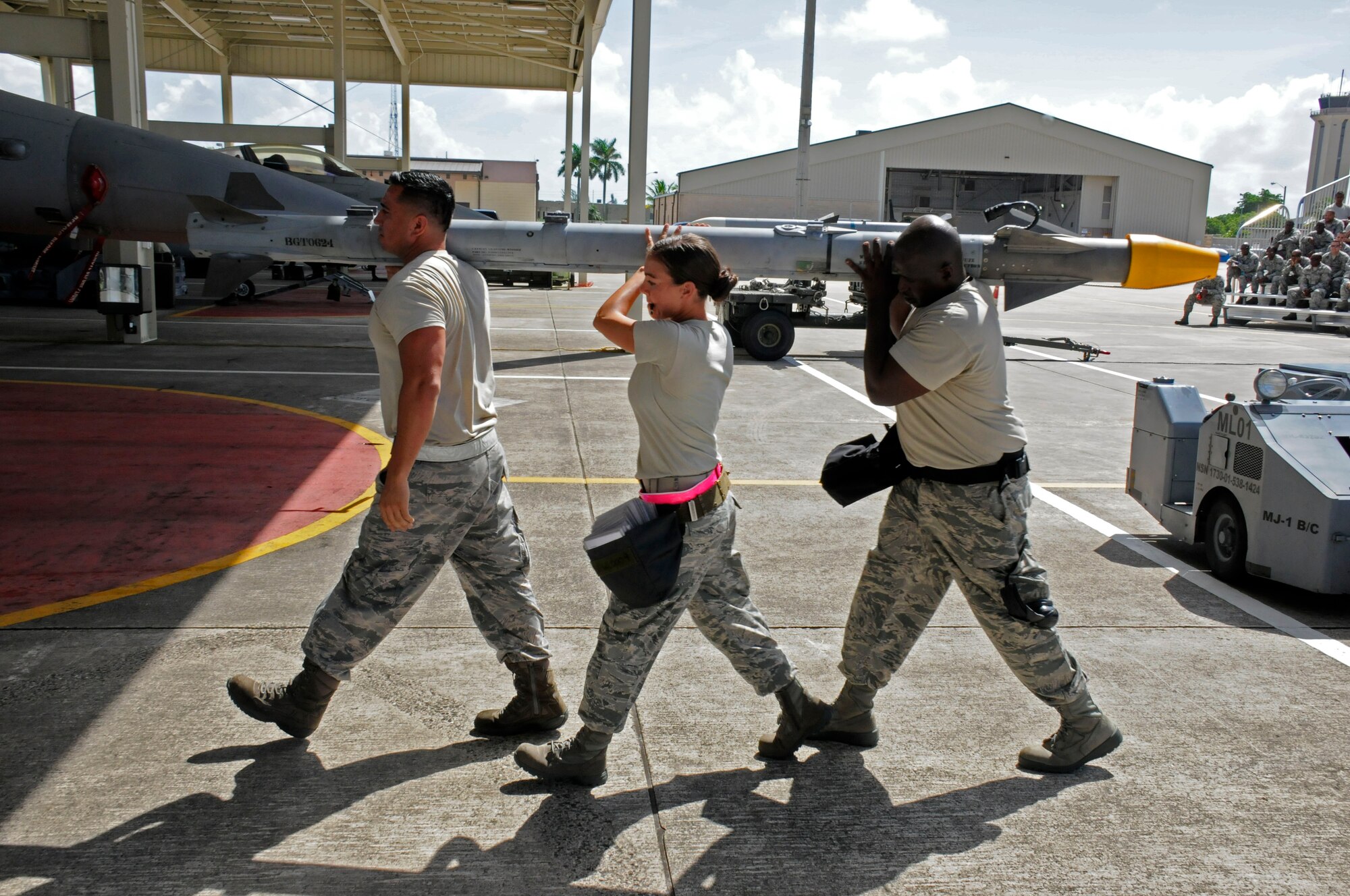 Tech. Sgt. Valerie Carde, Staff Sgt. Byron Jay and Staff Sgt. Jose
Contreras, all of the 482nd Aircraft Maintenance Squadron, carry an inert
missile to an F-16 during the 482nd Aircraft Maintenance Squadron's Load
Crew of the Year Competition at Homestead Air Reserve Base, Fla., July 13.
The "Load Toads" were evaluated in four areas to determine the winner: dress
and personal appearance, tool kit inspection, a general knowledge test, and
actual munitions loading to include speed and proficiency. (U.S. Air Force
photo/Senior Airman Nicholas Caceres)