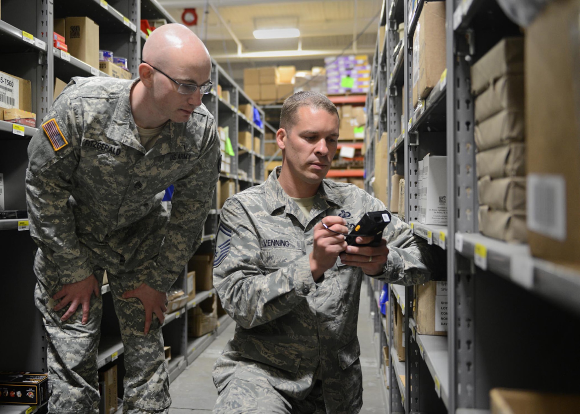 Senior Master Sgt. Michael Venning, 673d Contracting Squadron superintendent, uses the "3-in-1" Tool, a contingency contracting purchasing device, to assist an Army customer purchase some supplies at Joint Base Elmendorf-Richardson, Alaska, July 12, 2014. Venning is one of the Air Force's 12 Outstanding Airmen of the Year. The award recognizes 12 outstanding enlisted service members for superior leadership, job performance, community involvement and personal achievements. (U.S. Air Force photo/Airman 1st Class Ty-Rico Lea)