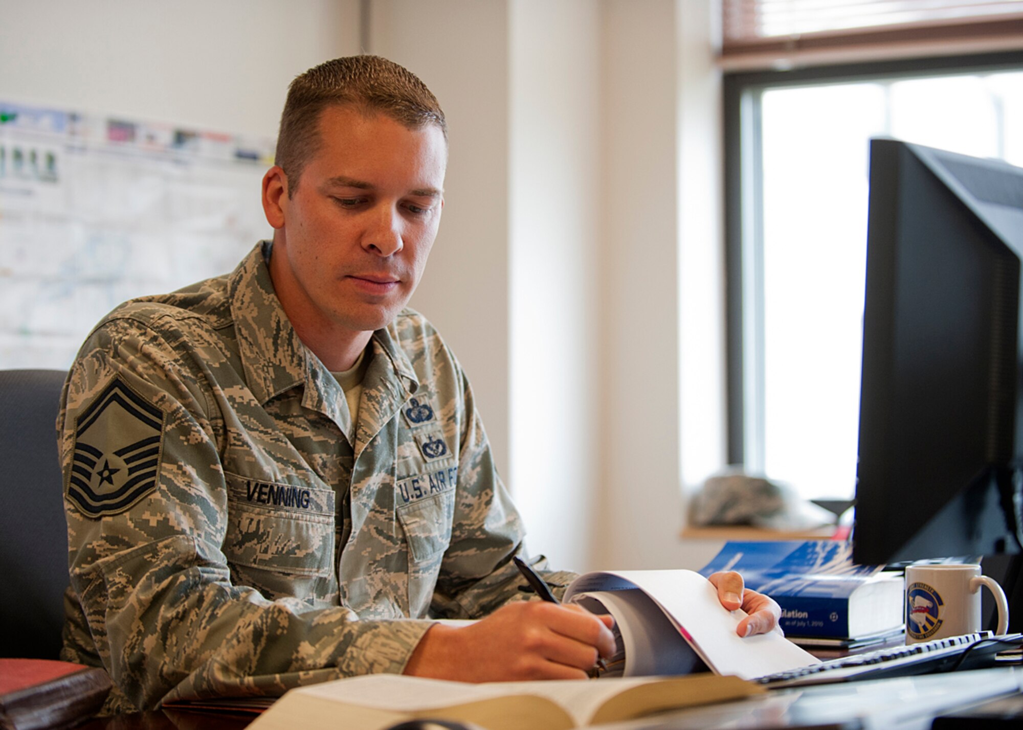 Senior Master Sgt. Michael Venning, 673d Contracting Squadron superintendent, reviews a contract file prior to contract award at Joint Base Elmendorf-Richardson, Alaska, July 12, 2014. Venning is one of the Air Force's 12 Outstanding Airmen of the Year. The award recognizes 12 outstanding enlisted service members for superior leadership, job performance, community involvement and personal achievements. (U.S. Air Force photo/Airman 1st Class Ty-Rico Lea)