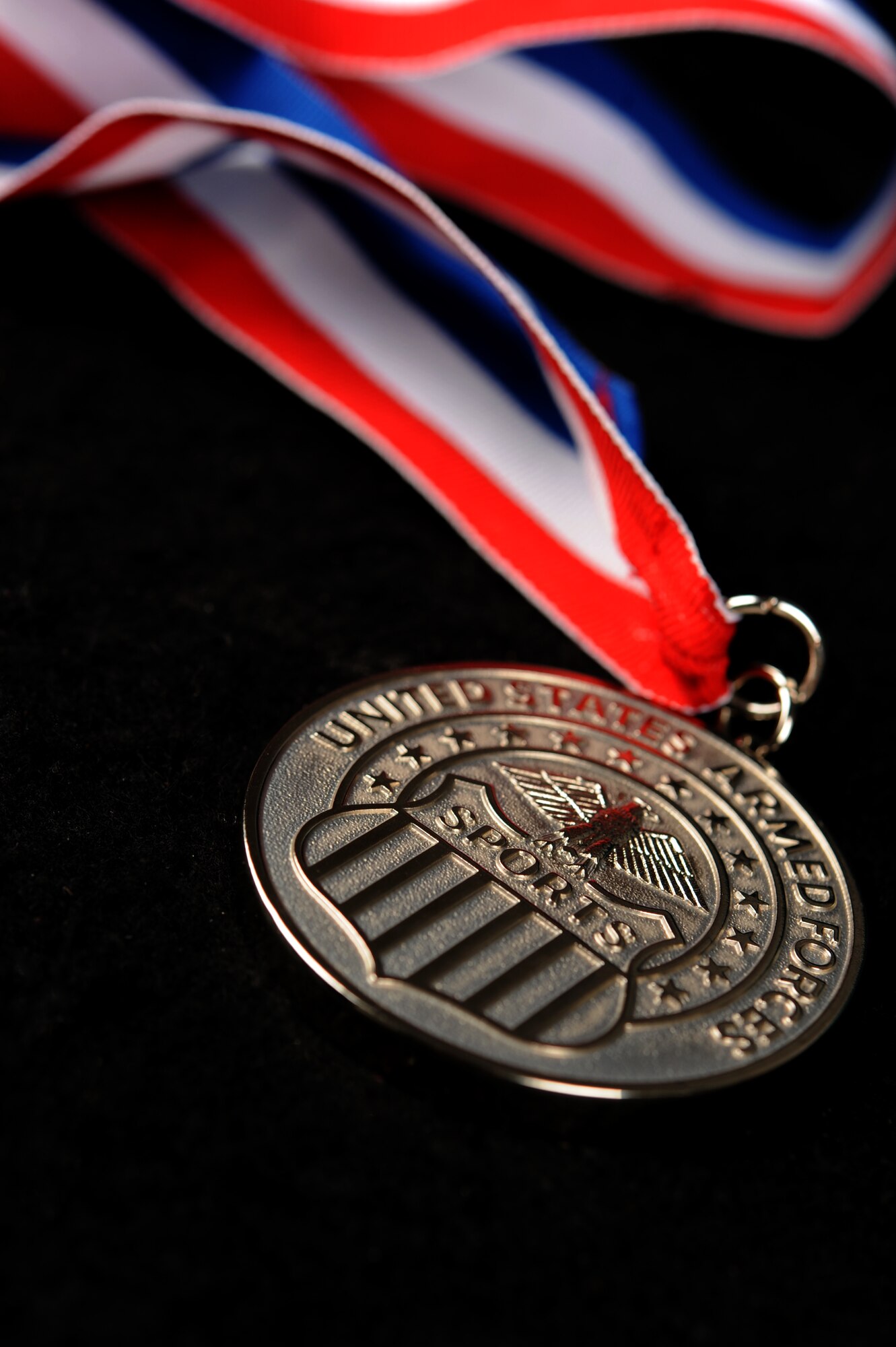 The silver medal earned by U.S. Air Force Staff Sgt. Shermika Harris, 633rd Security Forces Squadron patrolman, and her team is displayed at Langley Air Force Base, Va., July 10, 2014. Harris earned her medal after the U.S. Air Force team placed second to the U.S. Army during the Armed Forces Volleyball Championship. (U.S. Air Force photo by Airman 1st Class Areca T. Wilson/Released) 