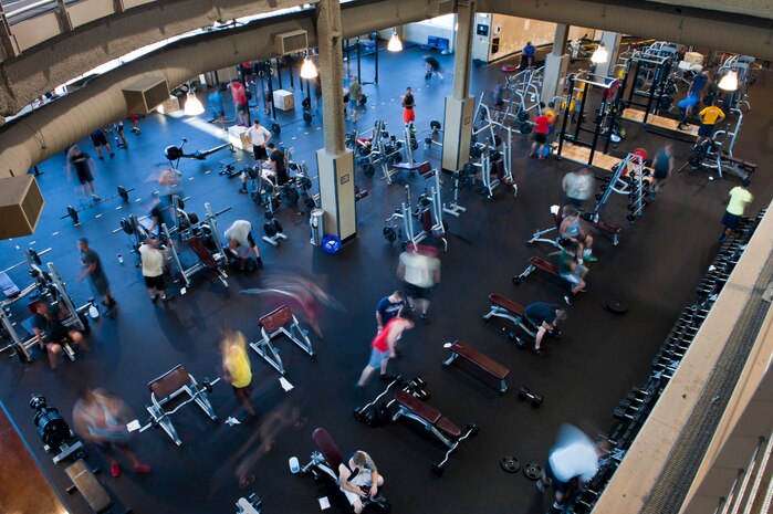 Service members from different bases and branches lift weights at the Warrior Fitness Center, July 14, 2014, at Nellis Air Force Base, Nev. During Red Flag, the Warrior Fitness Center sees an increase in approximately 200 to 300 people per day using the facility. This is due to the increase in the number of service members on base during Red Flag. (U.S. Air Force photo by Airman 1st Class Thomas Spangler)  
