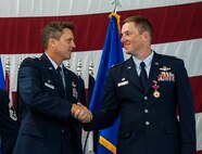 Col. Jason Armagost and Col. Alex Mezynski, shake hands after the 5th Bomb Wing Change of Command ceremony on Minot Air Force Base, N.D., July 14, 2014. During the ceremony Mezynski relinquished command of the 5th Bomb Wing to Armagost. (U.S. Air Force photo/Senior Airman Stephanie Morris)

