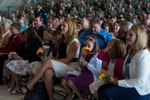 The families of Col. Alex Mezynski and Col. Jason Armagost are given flowers during the 5th Bomb Wing Change of Command ceremony on Minot Air Force Base, N.D., July 14, 2014.The 5th BW includes a total force of approximately 3,800 military members as well as 587 civilian employees. (U.S. Air Force photo/Senior Airman Stephanie Morris)