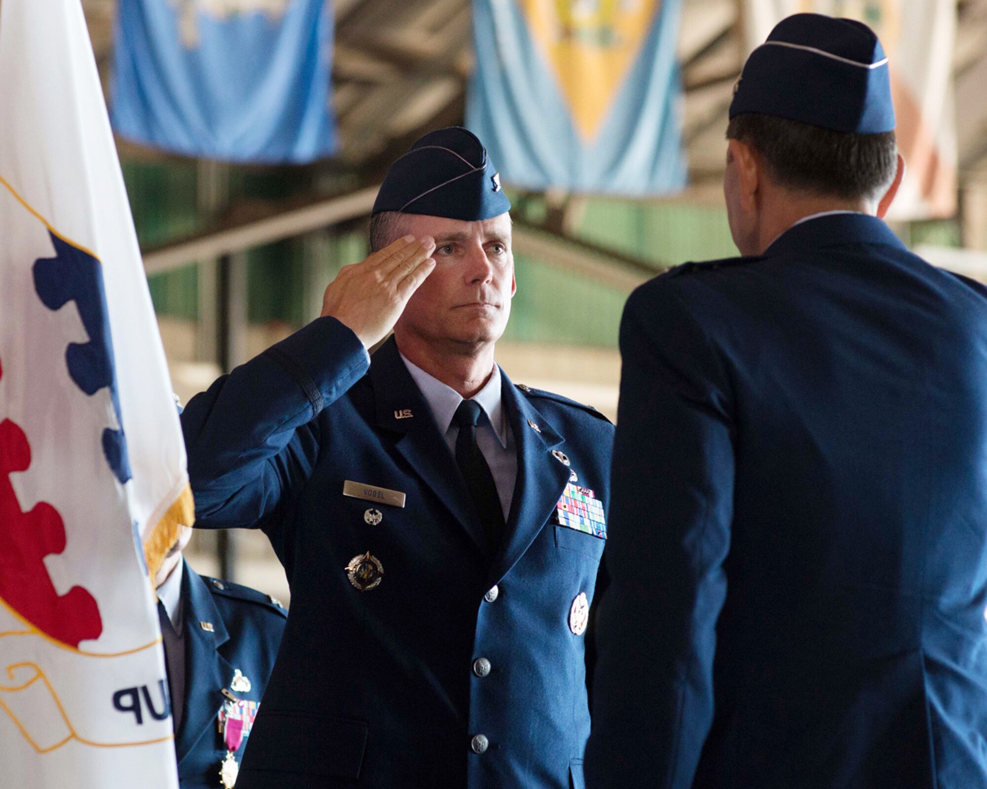 HANSCOM AIR FORCE BASE, Mass. – Col. Michael A. Vogel, 66th Air Base Group commander, salutes Lt. Gen. C. D. Moore II, Air Force Life Cycle Management Center commander, after accepting command of the 66th Air Base Group during the formal change of command ceremony at the Hanscom Aero Club Hangar July 10. Vogel is now looking forward to working closely with his ABG team, AFLCMC-Hanscom's program executive officers and with local elected and civic leaders. (U.S. Air Force photo by Mark Herlihy) 