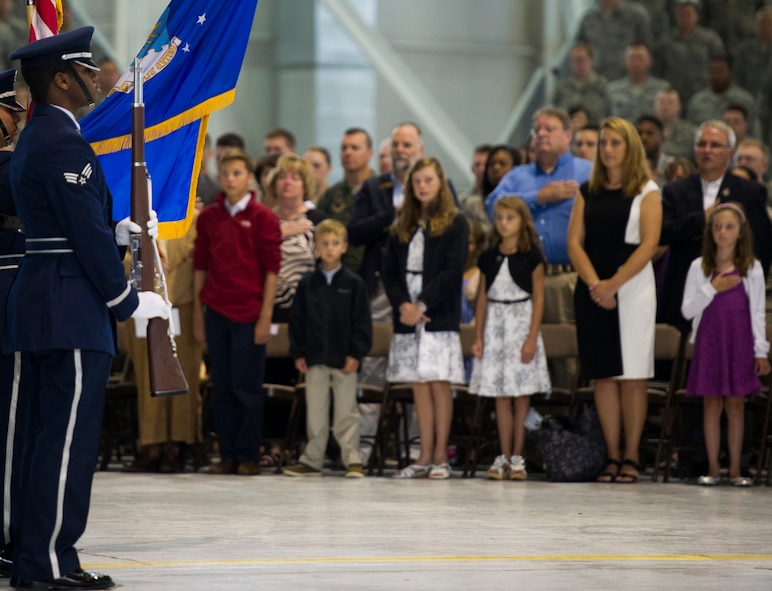 The family of Col. Jason Armagost stand as the Minot Air Force Base honor guard present the colors during the 5th Bomb Wing Change of Command ceremony on Minot Air Force Base, N.D., July 14, 2014.  Change of Command ceremonies are a time honored tradition dating back to the age of ancient Greece. (U.S. Air Force photo/Senior Airman Andrew Crawford)