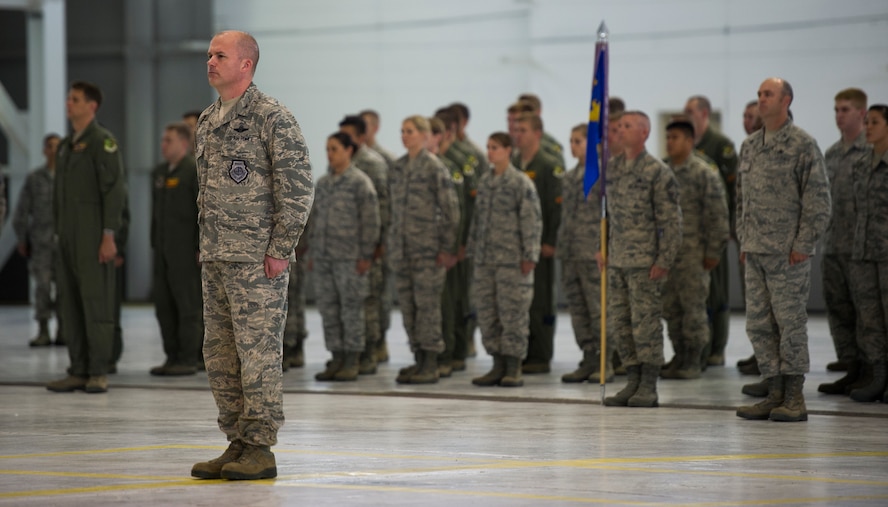 Col. Jeffrey Neischel, 5th Bomb Wing vice commander, directs Airmen of the 5th BW to assume the position of attention during the 5th BW Change of Command ceremony on Minot Air Force Base, N.D., July 14, 2014. During the ceremony, Col. Alex Mezynski relinquished command of the 5th BW to Col. Jason Armagost. (U.S. Air Force photo/Senior Airman Andrew Crawford)