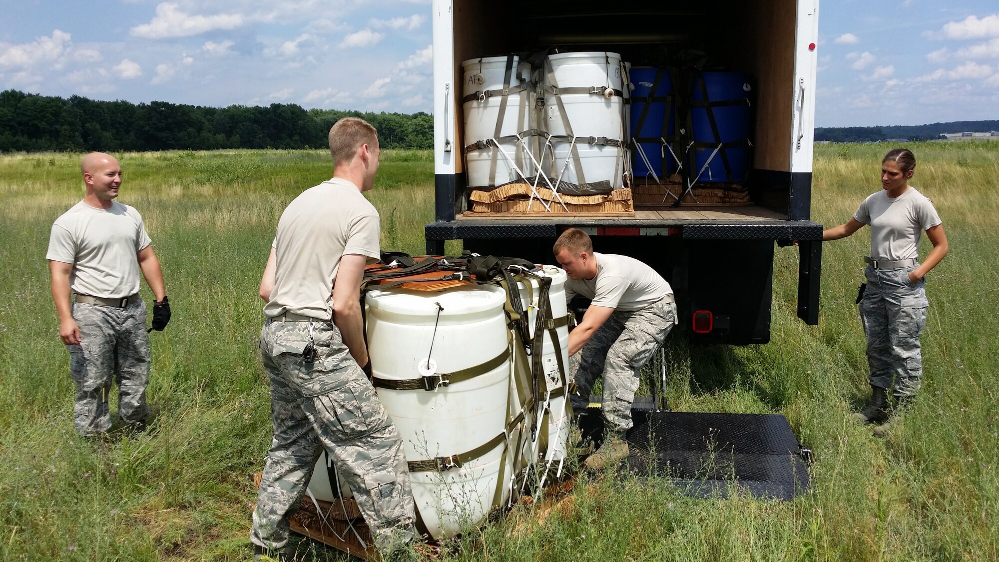 Airmen from the 103rd Logistics Readiness Squadron maneuver the container delivery system onto a truck after a successful air drop training exercise at Westover Air Reserve Base, Chicopee, Massachusetts on July 12, 2014. After collecting the systems, they will be brought back to Bradley Air National Guard Base, East Granby, Connecticut, disassembled and repacked for the next mission. (Air National Guard photo by Tech. Sgt. Joshua Mead/Released)