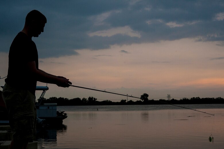 SAN ANGELO, Texas-- Airman 1st Class Travis E. Hill, 17th Communications Squadron focal point technician, prepares to cast out his line while fishing at the Goodfellow Air Force Base Recreational Camp June 26. The recreational camp sits on the shore of Lake Nasworthy and is home to largemouth bass, crappie and catfish. (U.S. Air Force photo/ Senior Airman Michael Smith)