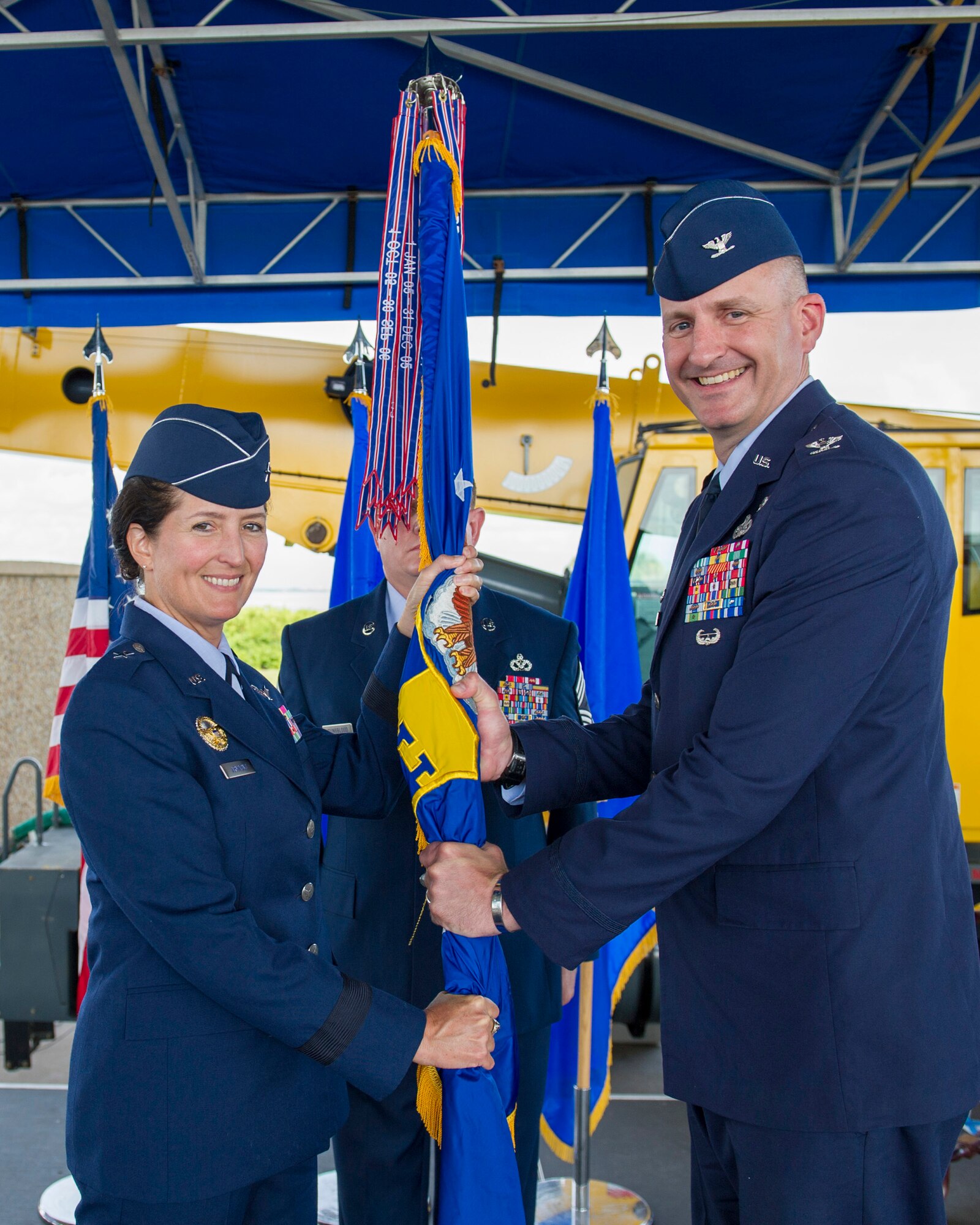 Brig. Gen. Nina Armagno, 45th Space Wing commander, left, presents Col. Glen Christensen, 45th Mission Support Group commander, with the 45th MSG guidon during a change of command ceremony July 11, 2014, at Patrick Air Force Base, Fla. Changes of command are a military tradition representing the transfer of responsibilities from the presiding officials to the upcoming official. (U.S. Air Force photo/Matthew Jurgens)