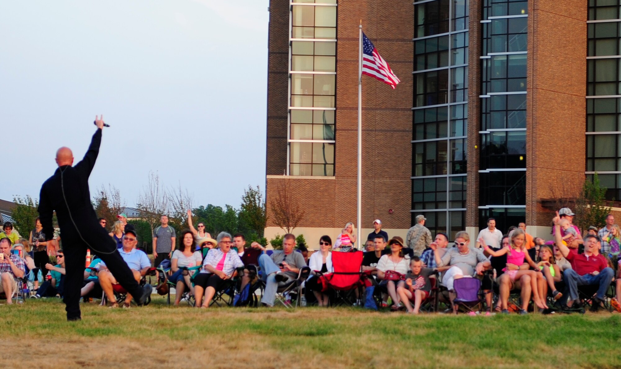 Senior Master Sgt. Ryan Carson, a vocalist for "Max Impact," interacts with audience members at the Joint Base Andrews Heritage Park Concert, July 12, 2014.  The concert series was designed to show appreciation to the local community for their support and showcase JBA's dedicated Airmen. This was the second of three concerts scheduled for this summer. (U.S. Air Force photo/Staff Sgt. Torey Griffith)