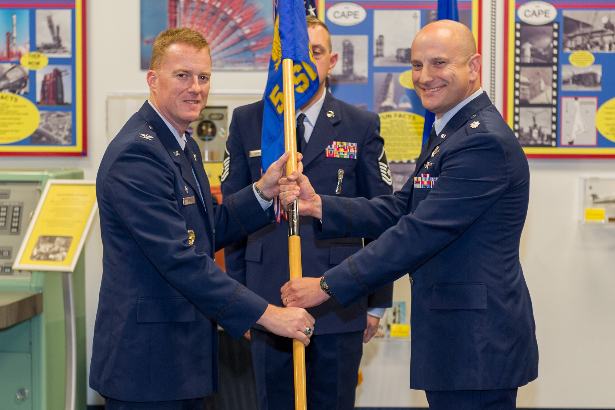 Col. Matthew E. Skeen, 45th Launch Group commander, left, presents Lt. Col. David A. Leach, 5th Space Launch Squadron commander, with the 5th SLS guidon during a change of command ceremony July 9, 2014, at Cape Canaveral Air Force Station, Fla. Changes of command are a military tradition representing the transfer of responsibilities from the presiding officials to the upcoming official. (U.S. Air Force photo/Cory Long)
