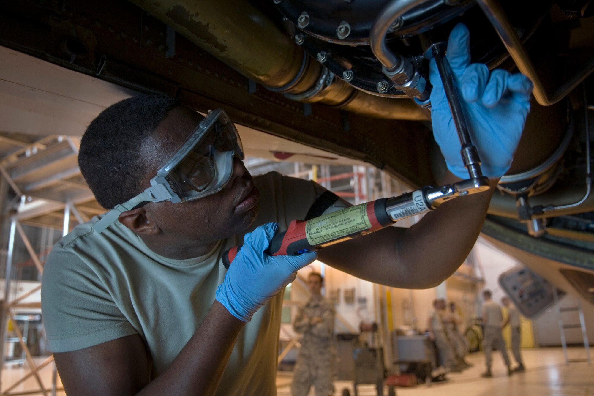 Airman 1st Class Atkinson Giavante , 434th Aircraft Maintenance Squadron crew chief, uses a torque wrench to tighten an oil drain plug from a KC-135R air cycle machine during a home-station check at Grissom Air Reserve Base, Ind., July 12, 2014. An ACM is a refrigeration unit of an environmental control system on KC-135s used to provide cabin ventilation.  (U.S. Air Force photo/Staff Sgt. Ben Mota)