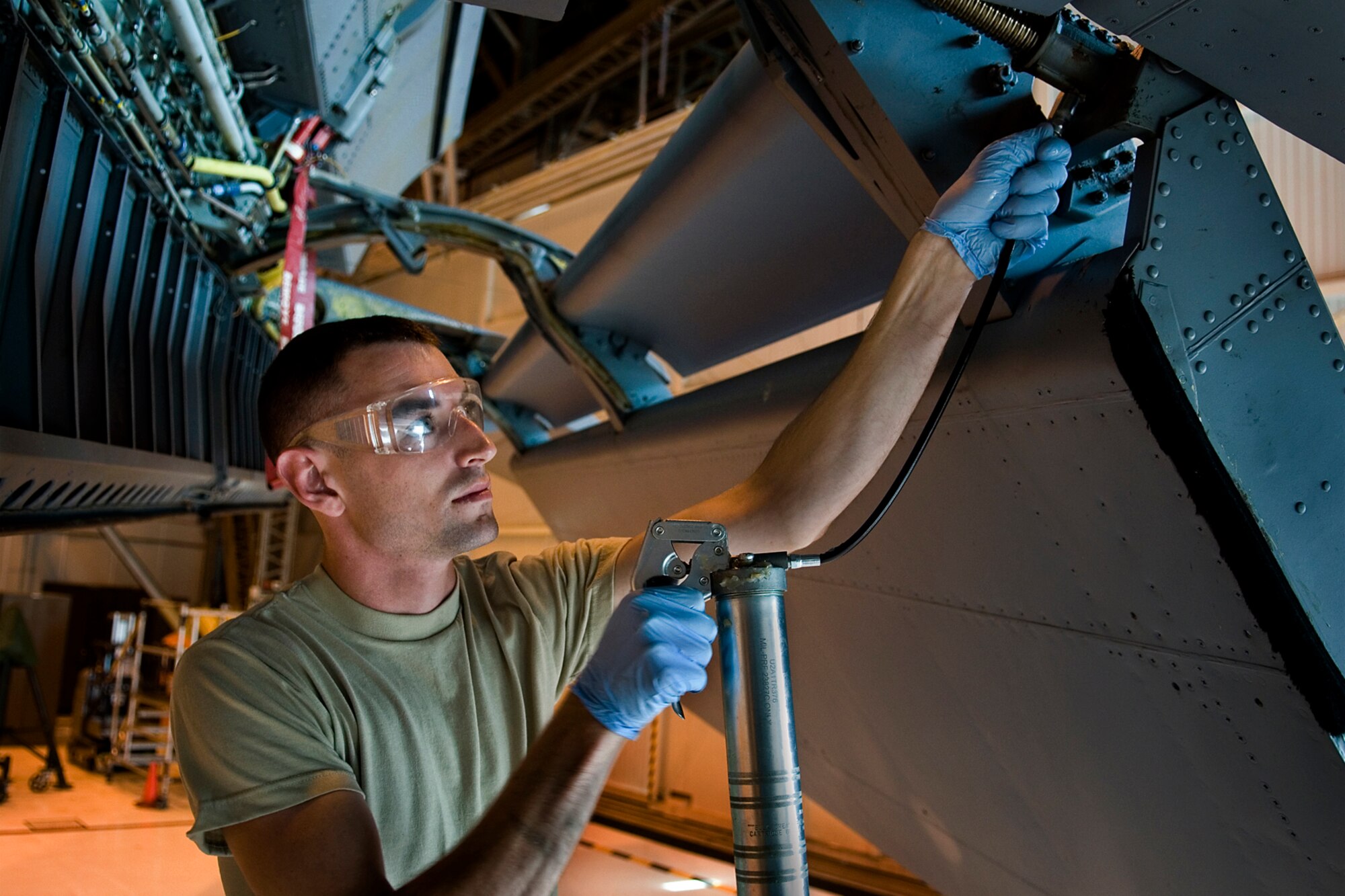 Senior Airman Ryan Wilkinson, 434th Aircraft Maintenance Squadron crew chief, lubricates wing flaps of a KC-135R Stratotanker during a home station check of the aircraft at Grissom Air Reserve Base, Ind., July 12, 2014. Home-station checks are conducted every 60 days and include lubrication of service components, various inspections, operational checks, servicing and repair of any identified discrepancies. (U.S. Air Force photo/Staff Sgt. Ben Mota)