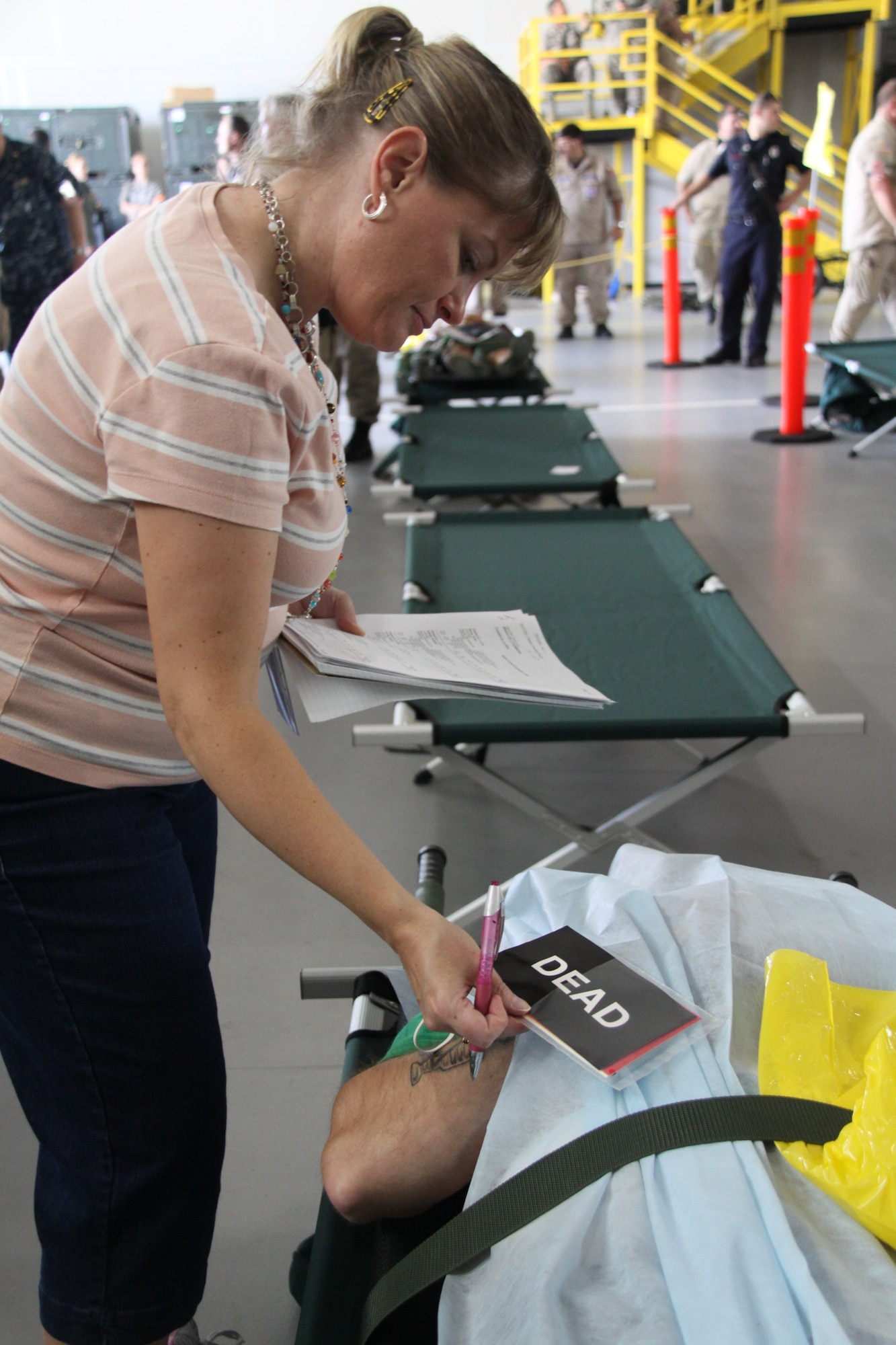 Renee Casey, a 911th Airlift Wing Casualty Augmentation Support Team member, checks the status of a simulated casualty during a National Disaster Medical System Exercise at the Pittsburgh International Airport Air Reserve Station, July 12, 2014. (U.S. Air Force photo by Staff Sgt. Jonathan Hehnly)