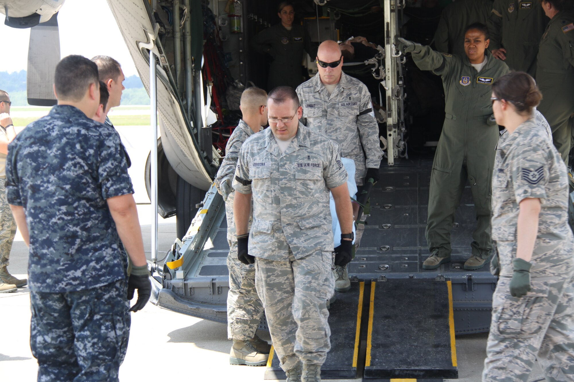 Master Sgts. Joseph Vergona  and Patrick Lehosit, 911th Aeromedical Staging Squadron members, off-load a simulated deceased victim from a C-130 Hercules aircraft, during a National Disaster Medical System Exercise at the Pittsburgh International Airport Air Reserve Station, July 12, 2014. (U.S. Air Force photo by Staff Sgt. Jonathan Hehnly)