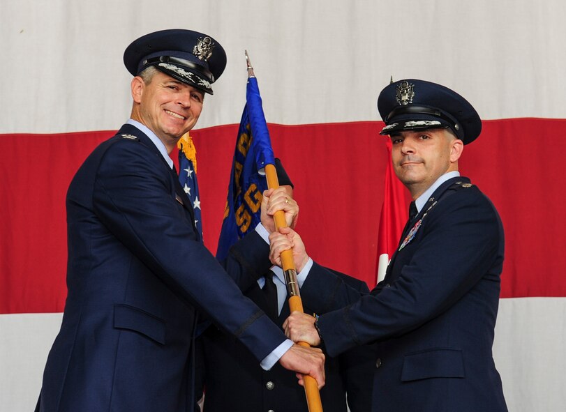 Col. Craig Wills, 39th Air Base Wing commander, passes the guidon to Lt. Col. Russell Voce, 39th Mission Support Group commander, during the 39th Mission Support Group change of command ceremony June 15, 2014, Incirlik Air Base, Turkey. The ceremony signified the transition of command from Col. Sean T. Gallagher to Voce.  (U.S. Air Force photo by Senior Airman Nicole Sikorski/Released)