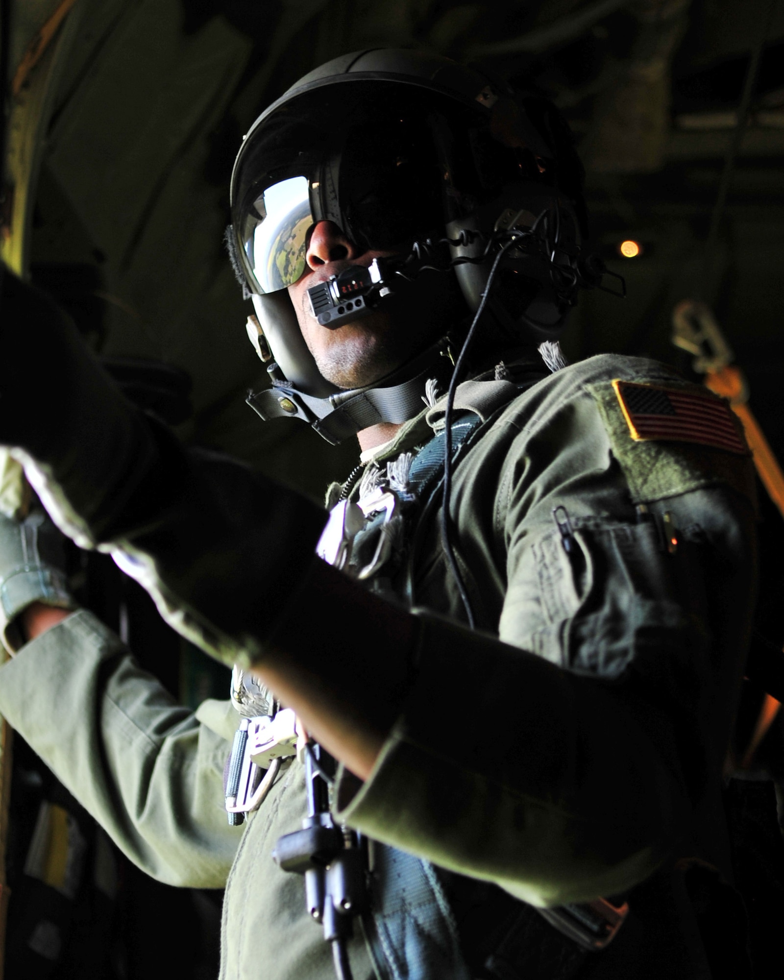 U.S. Air Force Airman 1st Class Ralph Colas, 37th Airlift Squadron loadmaster waits for the ok to allow U.S. Army soldiers from 1-91 Cavalry Regiment, 173rd Infantry Brigade Combat Team (Airborne), Grafenwoehr, Germany, to jump over Estonia, July 8, 2014. Airman Colas is from Queens, N.Y,, and is stationed at Ramstein Air Base, Germany. (U.S. Air Force photo by Senior Airman Christine Griffiths/Released)