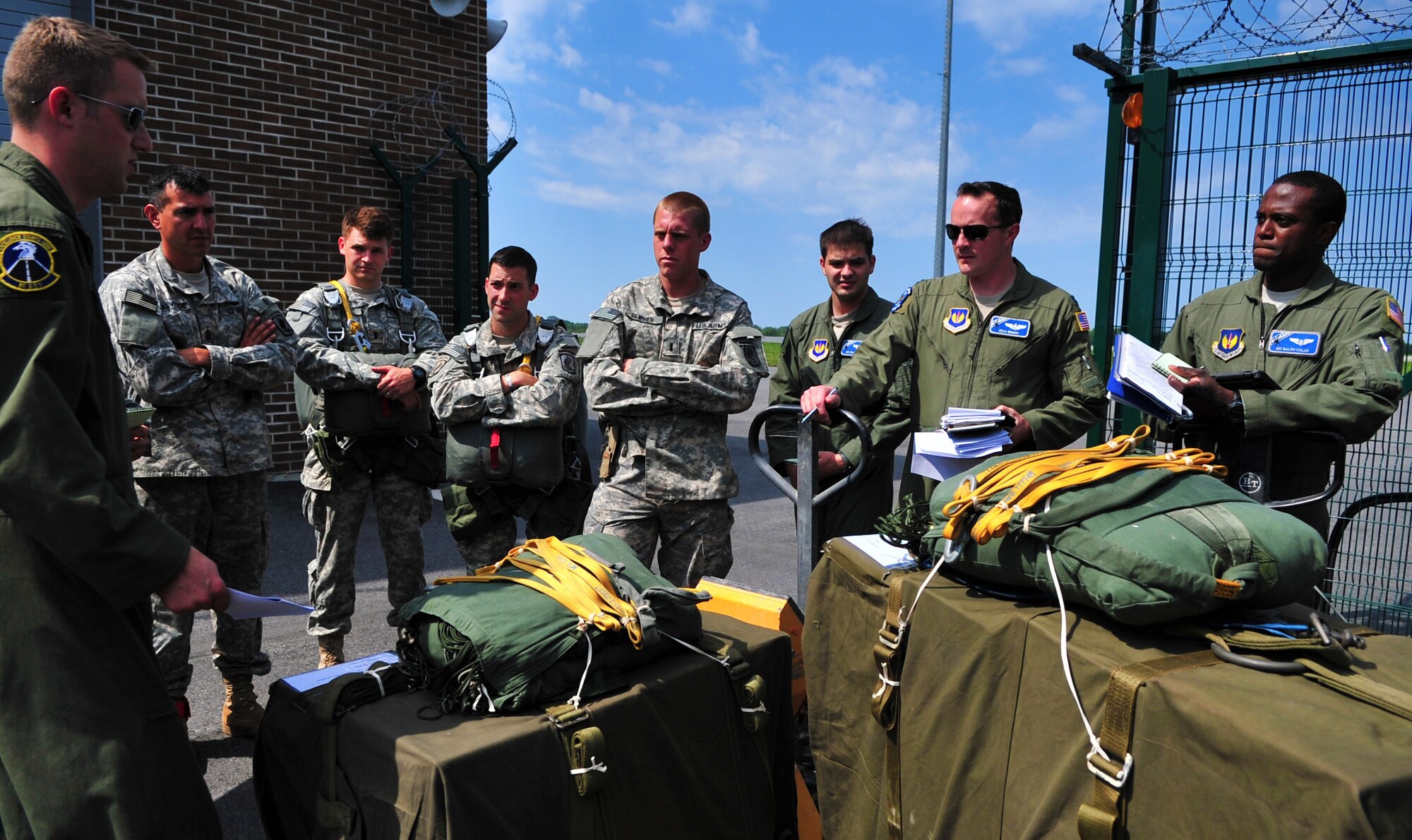 U.S. Air Force Airmen from the 37th Airlift Squadron perform a jump brief with U.S. army soldiers from 1-91 Cavalry Regiment, 173rd Infantry Brigade Combat Team (Airborne), Grafenwoehr, Germany, at Amari Air Base, Estonia, July 8, 2014. (U.S. Air Force photo by Senior Airman Christine Griffiths/Released)