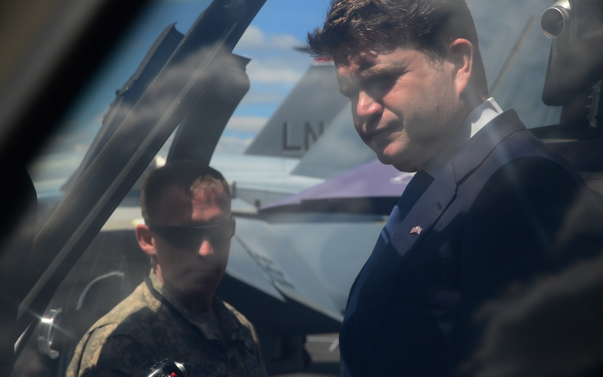1st Lt Hahns Seller briefs Ambassador Mathew Barzun, U.S. Ambassador to the United Kingdom on the UH-60 Blackhawk capabilities at Farnborough International Airshow, England, July 14, 2014. U.S. presence at the show promotes strong ties with NATO and Europe, and demonstrates U.S. industry is producing equipment critical to the success of current and future military operations. Seller is an HH-60 Blackhawk pilot assigned to Alpha Company, 1-214 Combat Aviation Brigade (U.S. Air Force photo by Airman 1st Class Erin O'Shea)