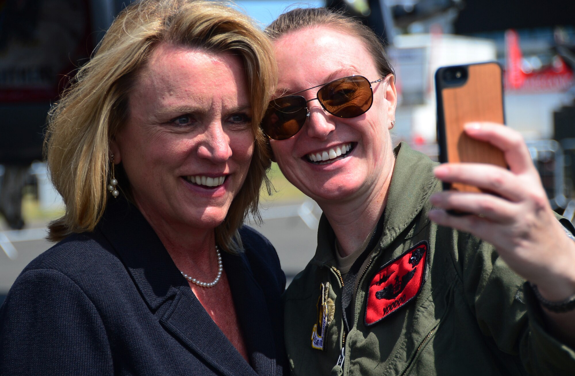 Secretary of the Air Force Deborah Lee James takes a "selfie" with Maj. Claire Lundberg, 494th Fighter Squadron weapon systems officer, at Farnborough International Airshow, England, July 14, 2014.  Secretary James, attending her first Farnborough International Airshow as Secretary of the Air Force, met with military, international and industry members to further partnerships and demonstrate the Air Force’s continued commitment to security and international cooperation. (U.S. Air Force photo by Airman 1st Class Erin O'Shea)
