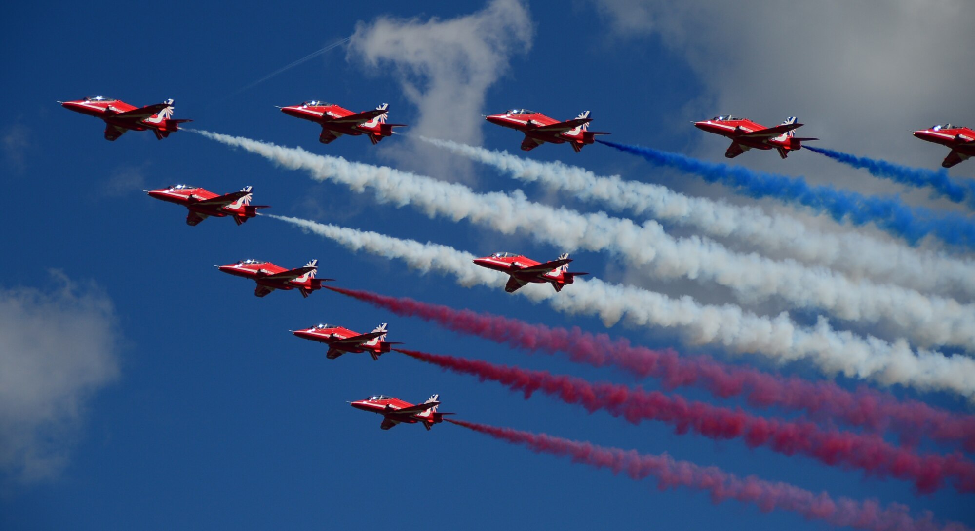 Royal Air Force Aerobatic Team, The Red Arrows, fly over a crowd during the Farnborough International Airshow, England, July 14, 2014.  Held every two years, Farnborough Airshow represents a unique opportunity for the U.S. and its allies to show case their leadership in aerospace technologies.(U.S. Air Force photo by Airman 1st Class Erin O'Shea).