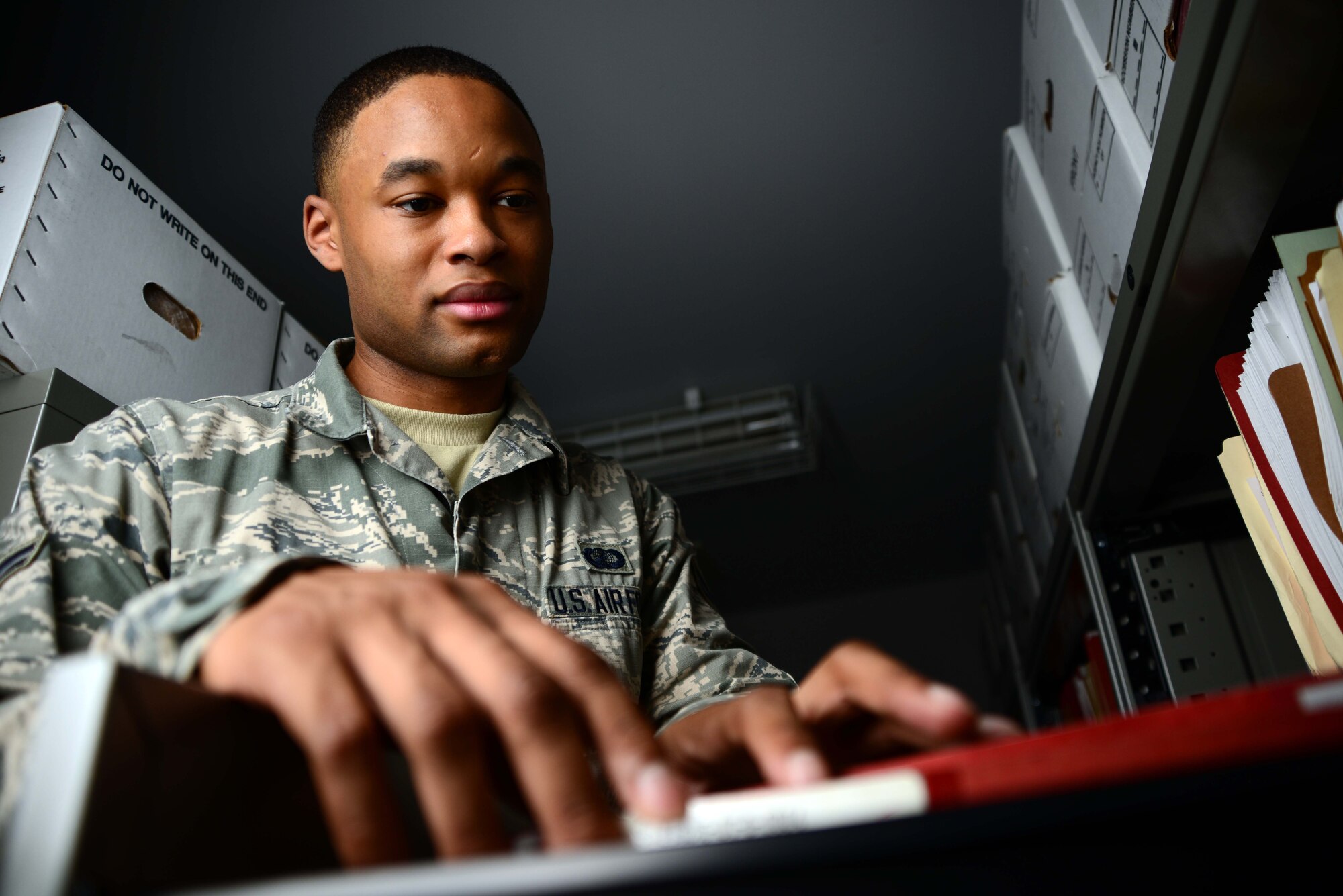 Airman 1st Class Teante Cain, 35th Contracting Squadron, searches for a customer's file July 14, 2014, at Misawa Air Base, Japan. As a contracting specialist, Cain provides acquisition support to the 35th Fighter Wing and its tenant units. Cain was named the 35th FW's Wild Weasel of the Week. (U.S. Air Force photo/Senior Airman Derek VanHorn)