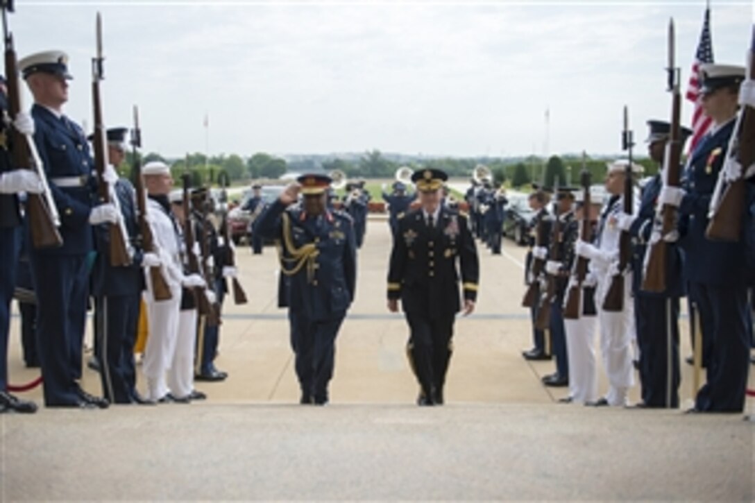 U.S. Army Gen.  Martin E. Dempsey, chairman of the Joint Chiefs of Staff, escorts Kenya’s Chief of Defense Forces Gen. Julius Waweru Karangi during an honor cordon at the Pentagon, July 15, 2014. Both military leaders met to discuss defense matters of mutual interest.