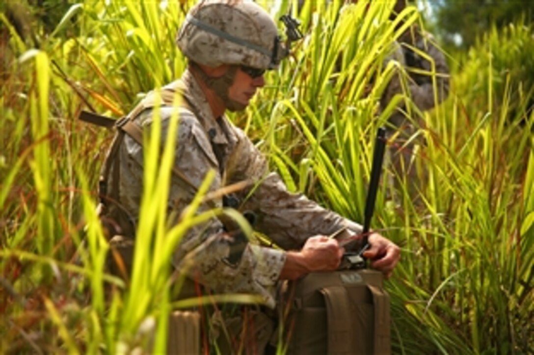 Marine 1st Sgt. Jason Marshall fixes his gear after leaving a CH53E Super Stallion helicopter during Rim of the Pacific Exercise 2014 on Kahuku Training Area, Hawaii, July 10, 2014. Marshall is company 1st sergeant for Company Landing Team 1. RIMPAC 2014 is the 24th exercise in the series that began in 1971.