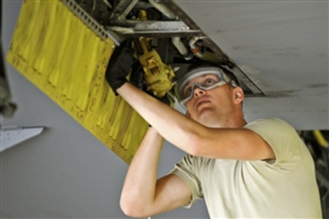 Airman 1st Class Brandon Johnson installs an outboard spoiler control valve on a KC-135 Stratotanker on McConnell Air Force Base, Kan., July 15, 2014. Johnson is an apprentice assigned to the 22nd Aerospace Maintenance Squadron.