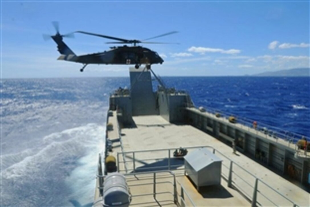 Army mariners from the 163rd Transportation Detachment and sailors with the Coastal Riverine Squadron 11, aboard the Harold C. Clinger, participate in a casualty evacuation exercise with the 25th Combat Aviation Brigade during Rim of the Pacific Exercise 2014 in Hawaii, July 10, 2014.