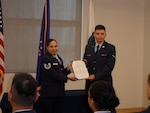 Tech. Sgt. Lisa Duffy presents the Honor Graduate citation to Airman Corbin Drysdale during the Health Services Management Apprentice class graduation ceremony on June 24. Duffy, a prior service Air National Guard member, had earned the distinction as the class Honor Graduate for carrying a 100% grade point average throughout the entire course. However, she declined the honor in favor of a classmate with no prior military experience which she viewed as an advantage to her success.  (Photo by Natasha Williams)
