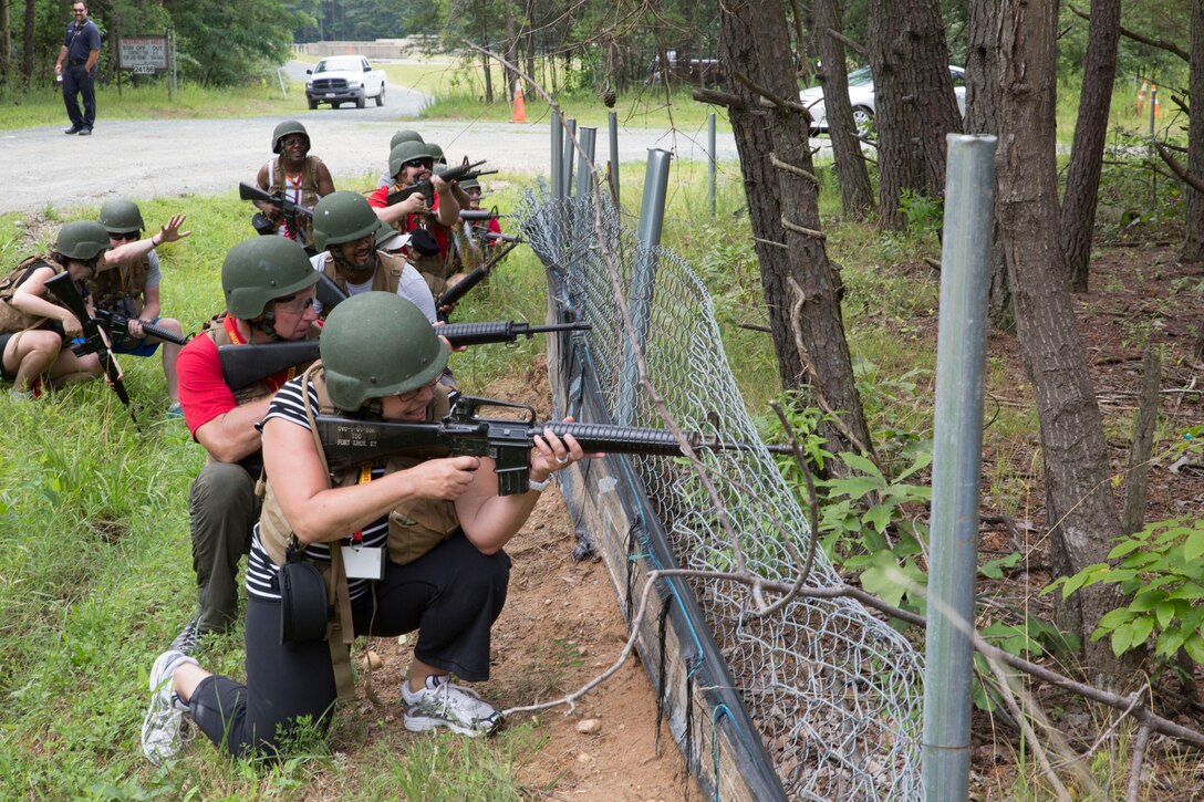 MARINE CORPS BASE QUANTICO, Va. (JULY 10, 2014) -- Guests of the 2014 Eastern Recruiting Region (ERR) Educators and Key Leaders Workshop repel enemy assault as part of a simulated patrol in The Basic School (TBS), here, today. The 2014 ERR Workshop takes place July 7-11, and helps build meaningful and purposeful relationships with those that have the privilege to guide America's leaders of tomorrow.