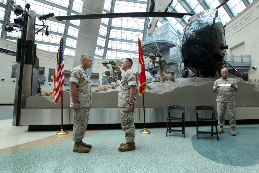 U.S. Marine Maj. James R. McGrath, Commanding Officer of Military Information Operations Company, Marine Corps Information Operations Center, is promoted to Lieutenant Colonel at the Marine Corps Museum, Triangle, Virginia, July 3, 2014. (U.S. Marine Corps photo by Sgt. Kristofer Atkinson/Released)