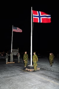 Members of the Minnesota National Guard and Norwegian military participate in a flag ceremony during the early hours of Feb. 9, 2012 in Norway. The Minnesota National Guard will be in Norway for the next two weeks as they participate in the Norwegian Exchange, a program that also allows for Norwegian military members to train in Minnesota.