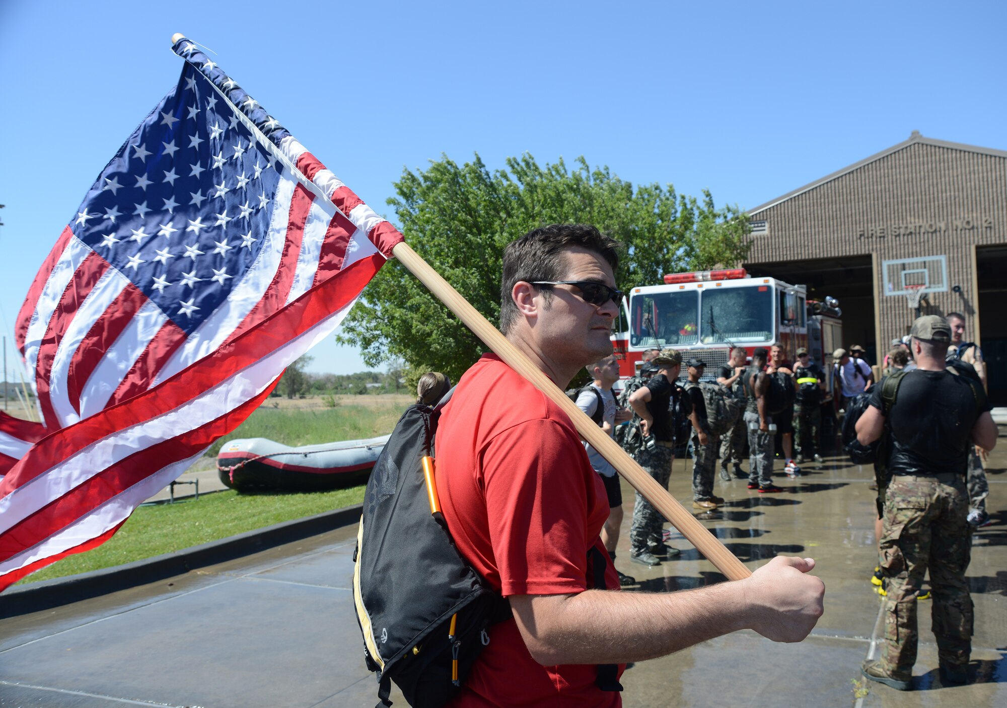 Benjamin Evers carries the United States flag July 12, 2014, at Mountain Home Air Force Base, Idaho. Evers held the flag for participants while they performed challenges and obstacles during the GORUCK Light/Team Cohesion Challenge. Evers is an Air Force Personnel Center outdoor recreation operations specialist. (U.S. Air Force photo/Senior Airman Benjamin Sutton)