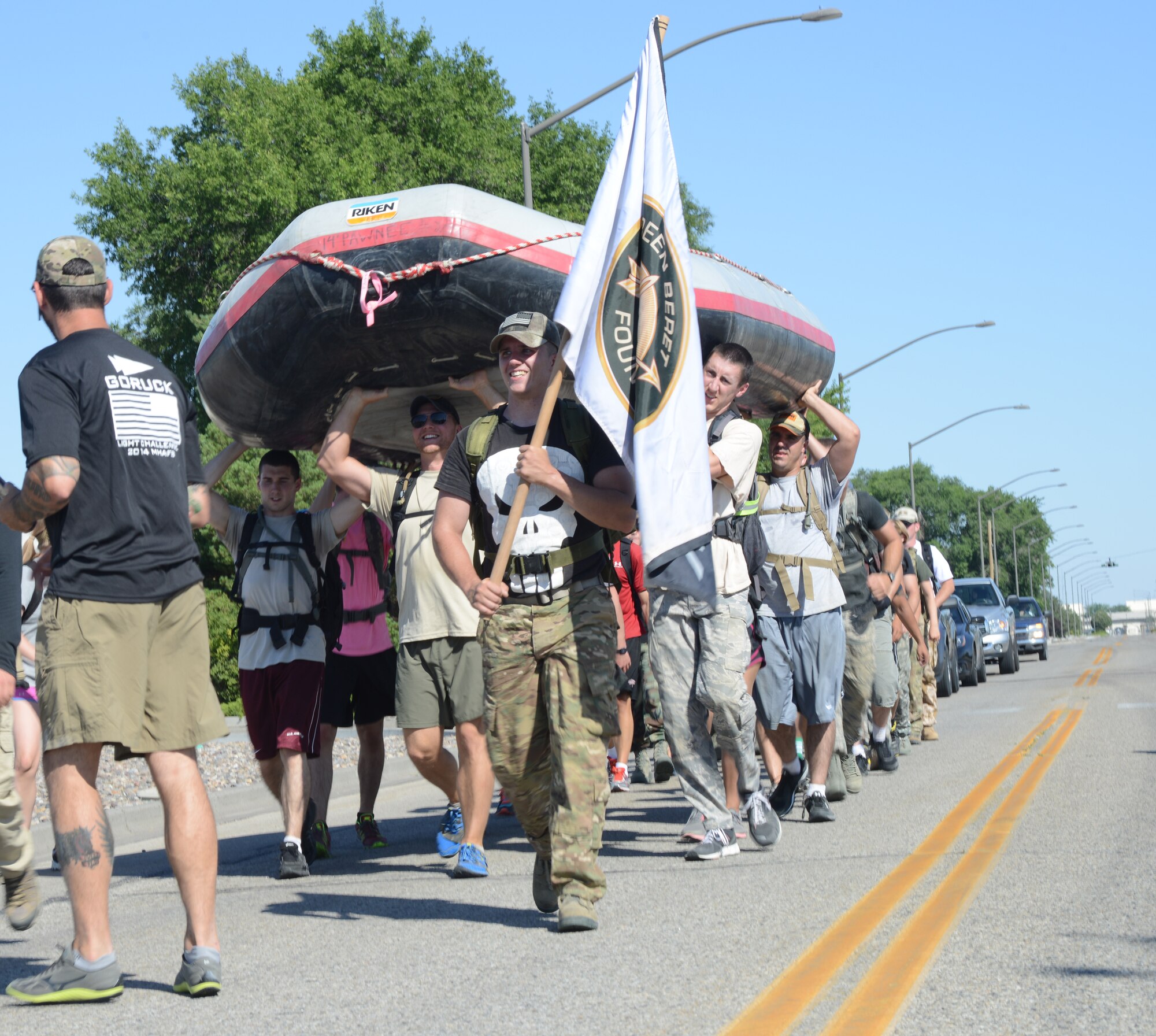 Members participating in the GORUCK Light Challenge carry a 250 pound raft on their shoulders July 12, 2014, at Mountain Home Air Force Base, Idaho. The new Air Force pilot program, Team Cohesion Challenge, is modeled after special operations training. (U.S. Air Force photo/Senior Airman Benjamin Sutton)