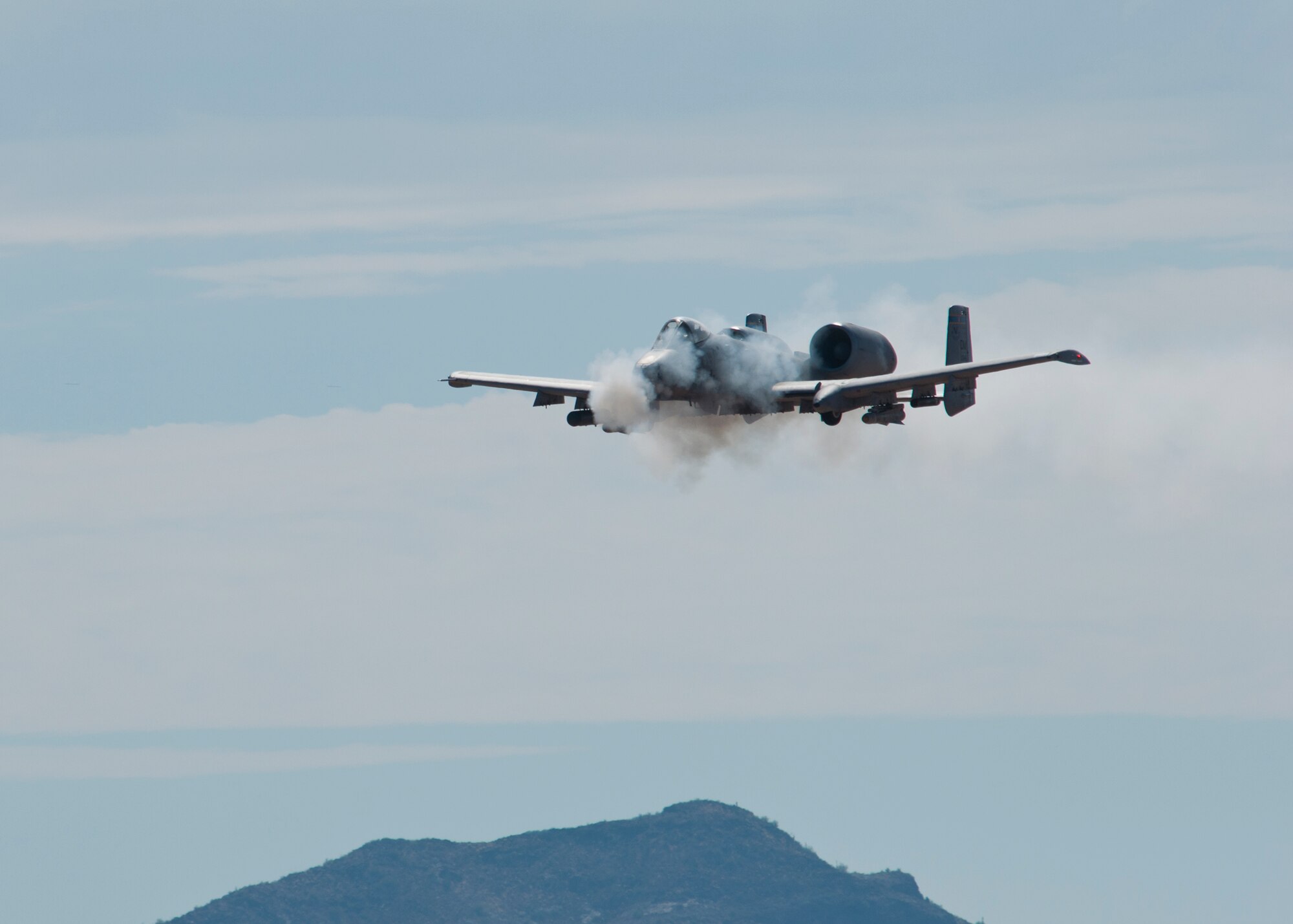 An A-10 Thunderbolt II from Davis-Monthan Air Force Base strafes during the 2014 Hawgsmoke competition July 10, 2014, at the Barry M. Goldwater Range II in Tucson, Ariz. Hawgsmoke is a biennial worldwide A-10 bombing, missile, and tactical gunnery competition. Four-ship teams of aircraft and pilots from A-10 units around the world compete for the honor of being the best in ground attack and target destruction. (U.S. Air Force photo/)